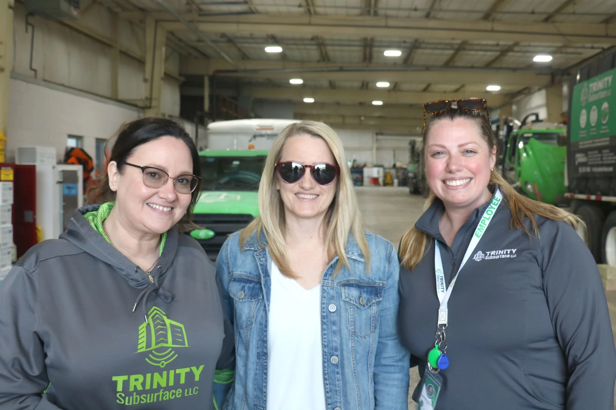 Katie, Karly, and Kaitlyn at a grill and chill event at the Trinity Subsurface shop building.