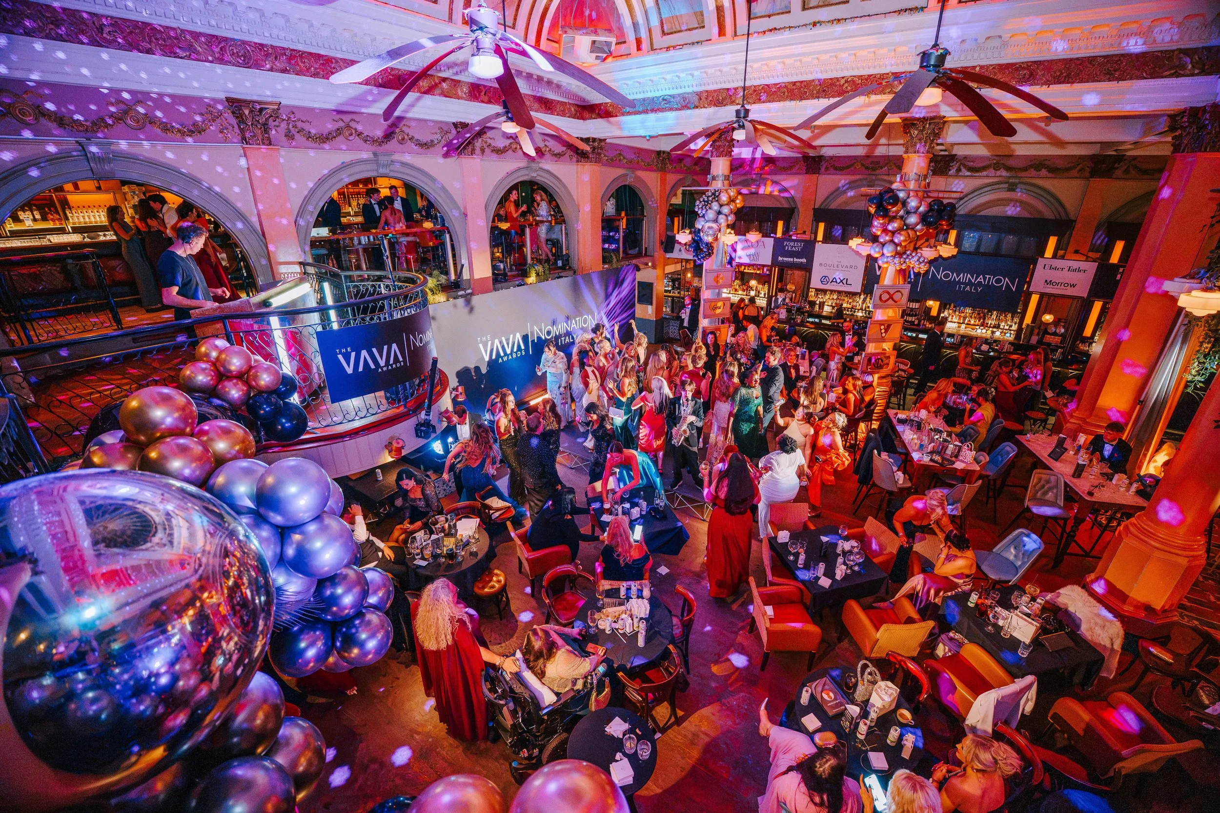 Wide view of the domed hall at Revolución de Cuba Belfast during the VAVA Awards after party, with coloured lighting across the ceiling and columns