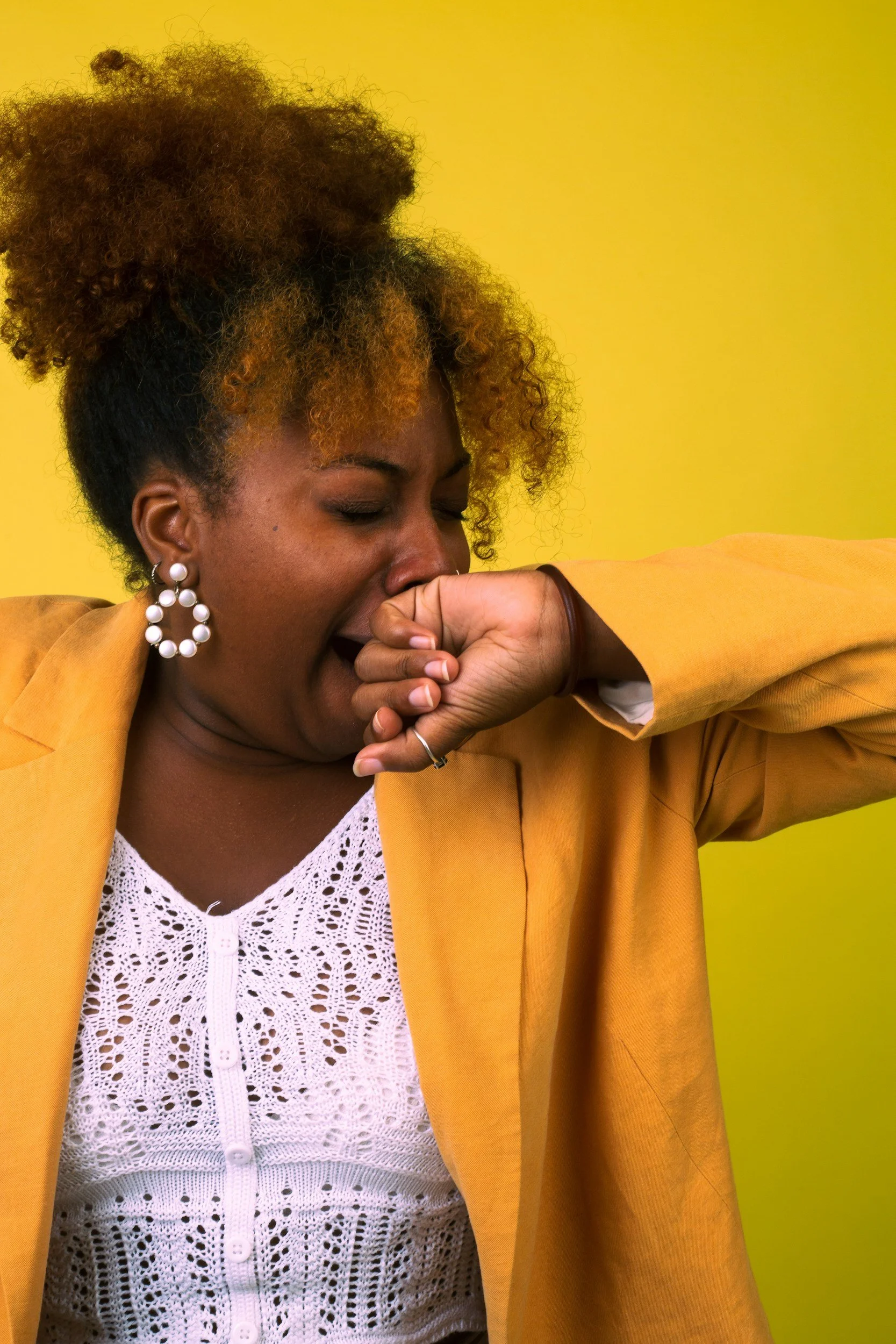 Black woman yawning because she is so exhausted from hustle culture. Does your work stress cause binge eating at night? Get California eating disorder therapy help from top San Diego therapist Dr Marianne Miller, specializing in autism and ADHD.