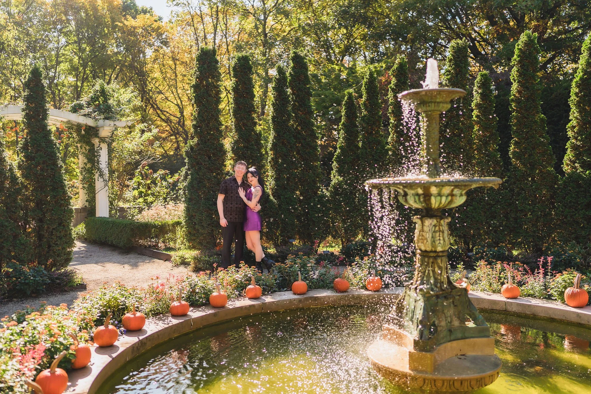 Natural couple portraits among the greenery during an outdoor engagement session at Newfields Museum in Indianapolis Indiana
