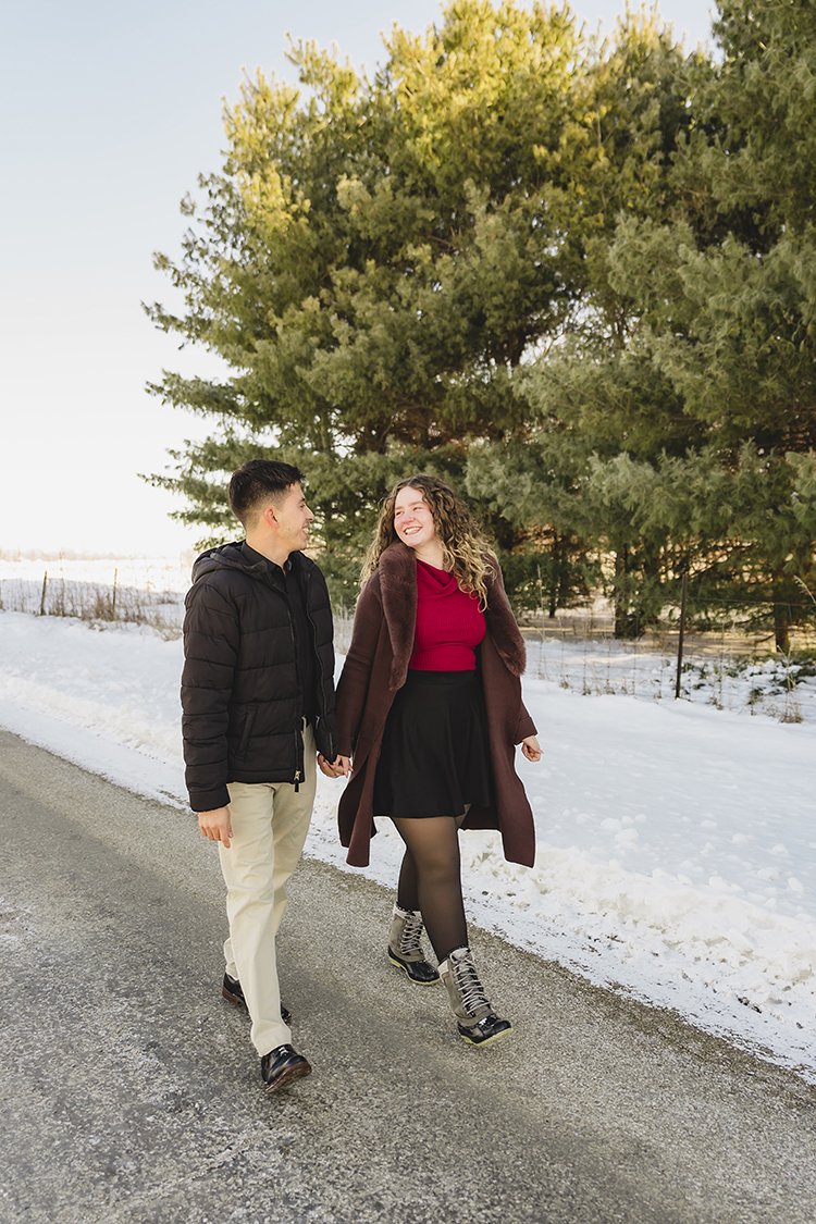 A couple, holding hands during their winter mini photo session.