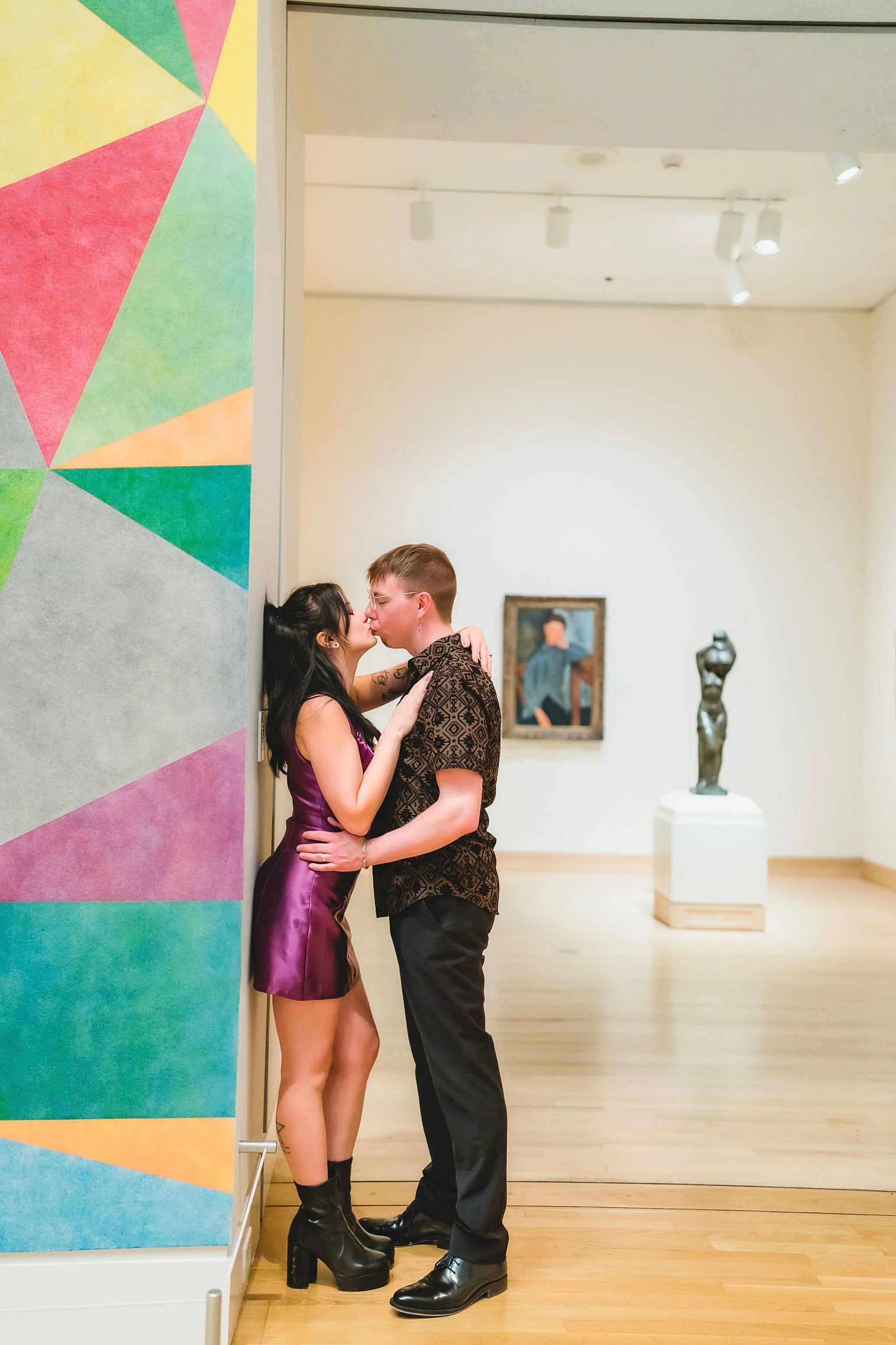 Couple posing together inside the art museum during their Newfields engagement session in Indianapolis Indiana