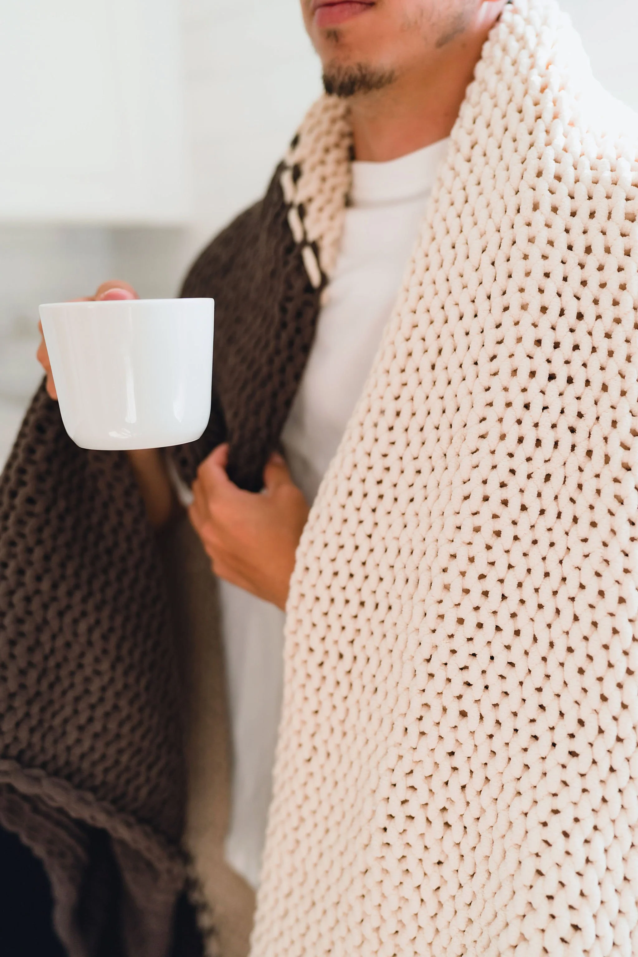 Neutral toned knit blanket folded in natural light during branding session