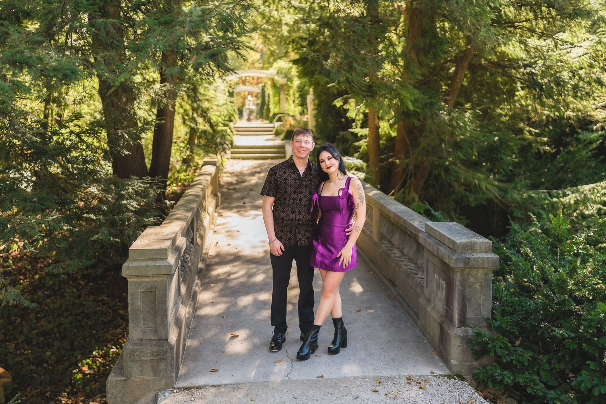 A couple smiles at the camera during their engagement photos