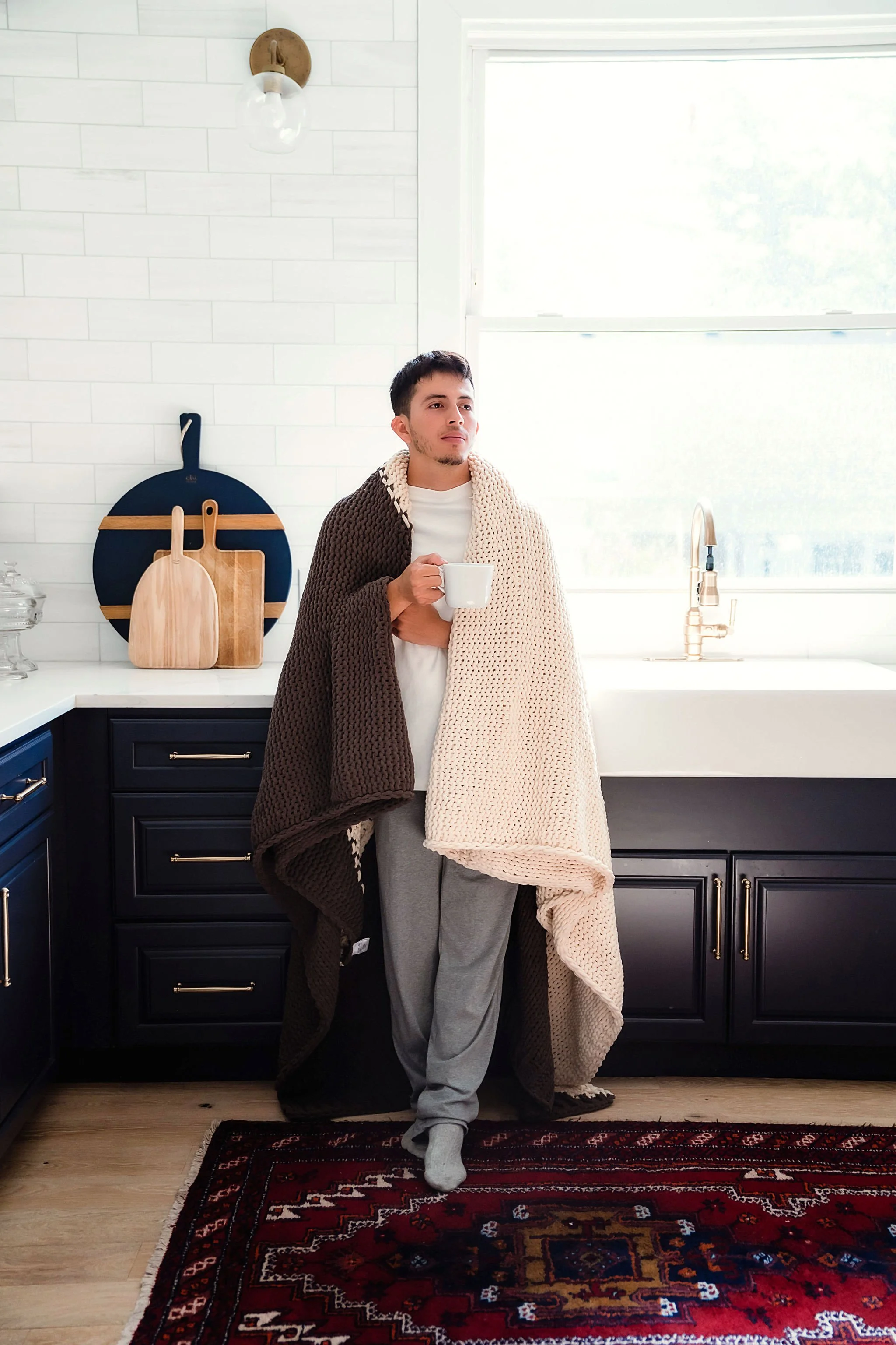 Natural light family photography featuring Little Giraffe knit blankets in real home environment