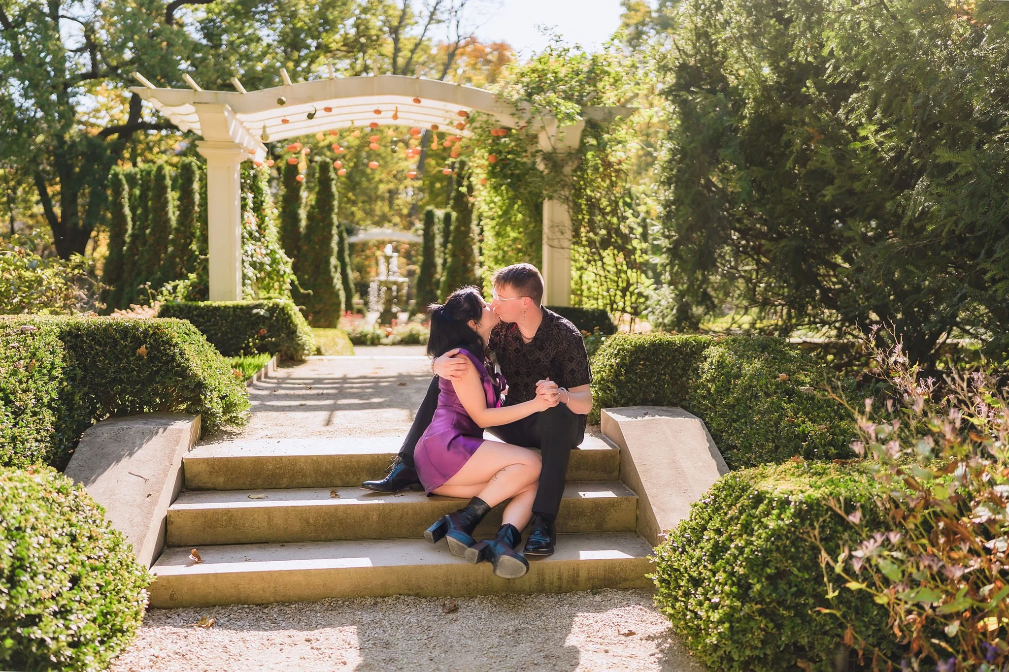 Engaged couple sharing a kiss during their garden engagement photography session in Indianapolis Indiana