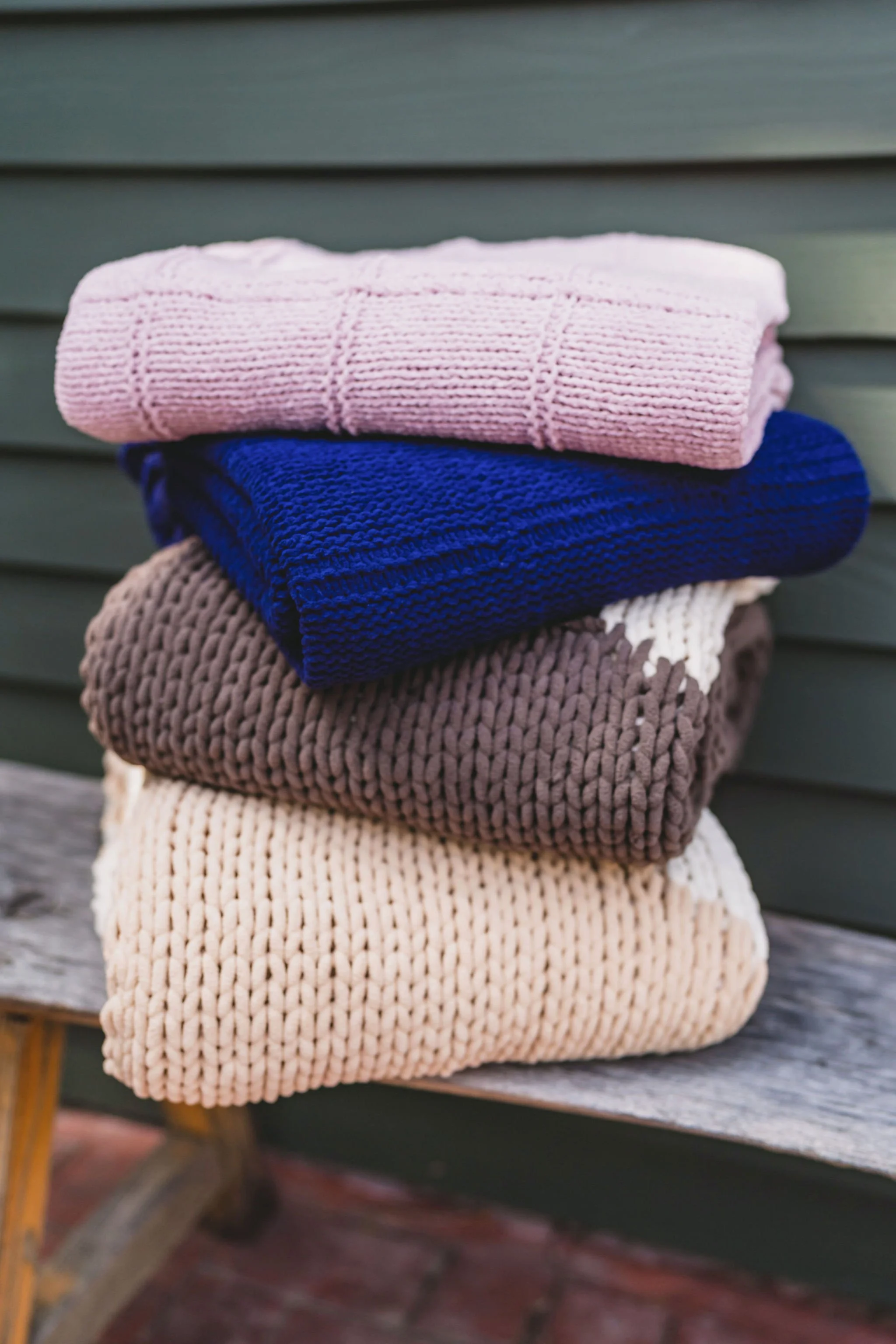 Lifestyle product photography highlighting softness of luxury knit blanket collection