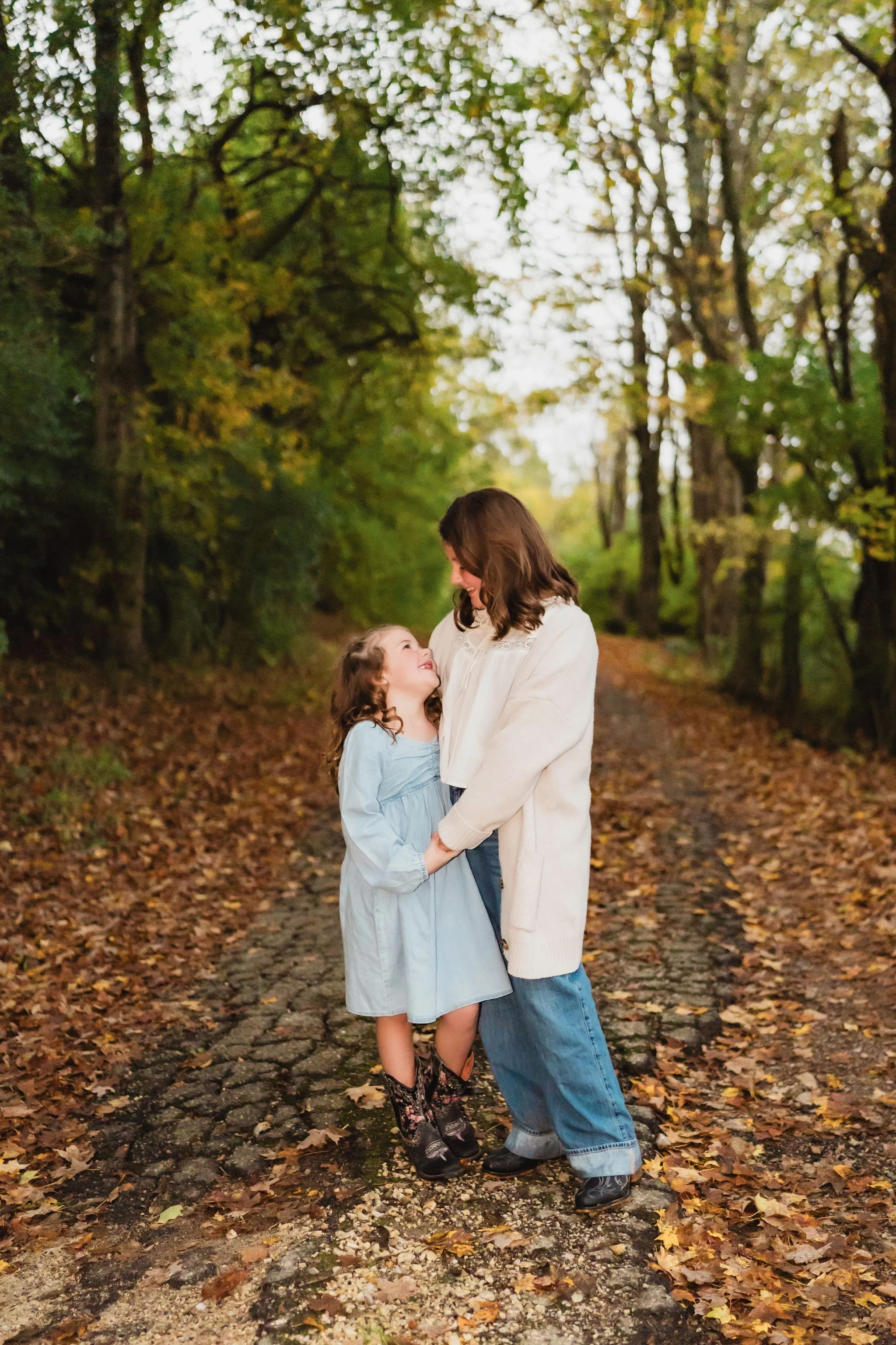 Sisters holding hands on the property where their future family home will stand.