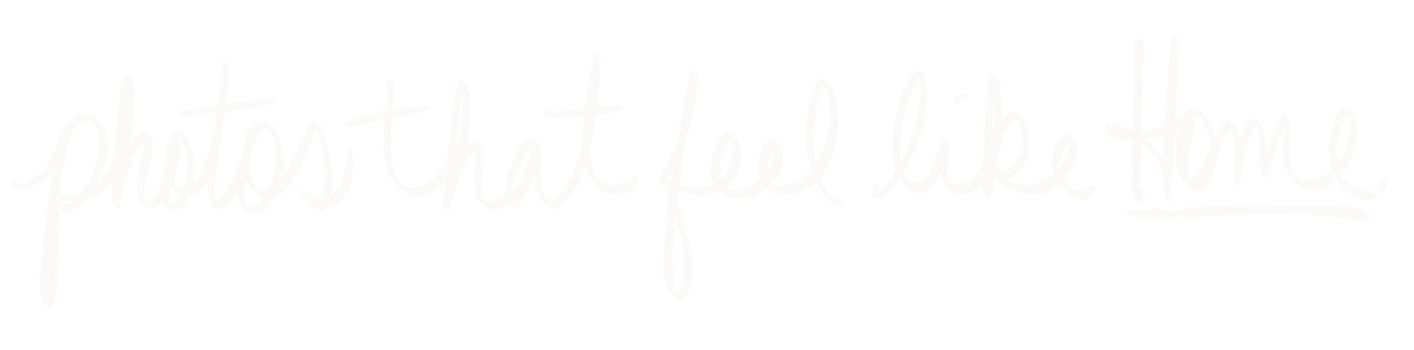 A woman in making a hand gesture and a man sitting at a table in front of a computer, in an office or conference room.