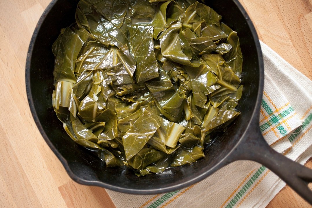Cast iron skillet of sauteed collard greens