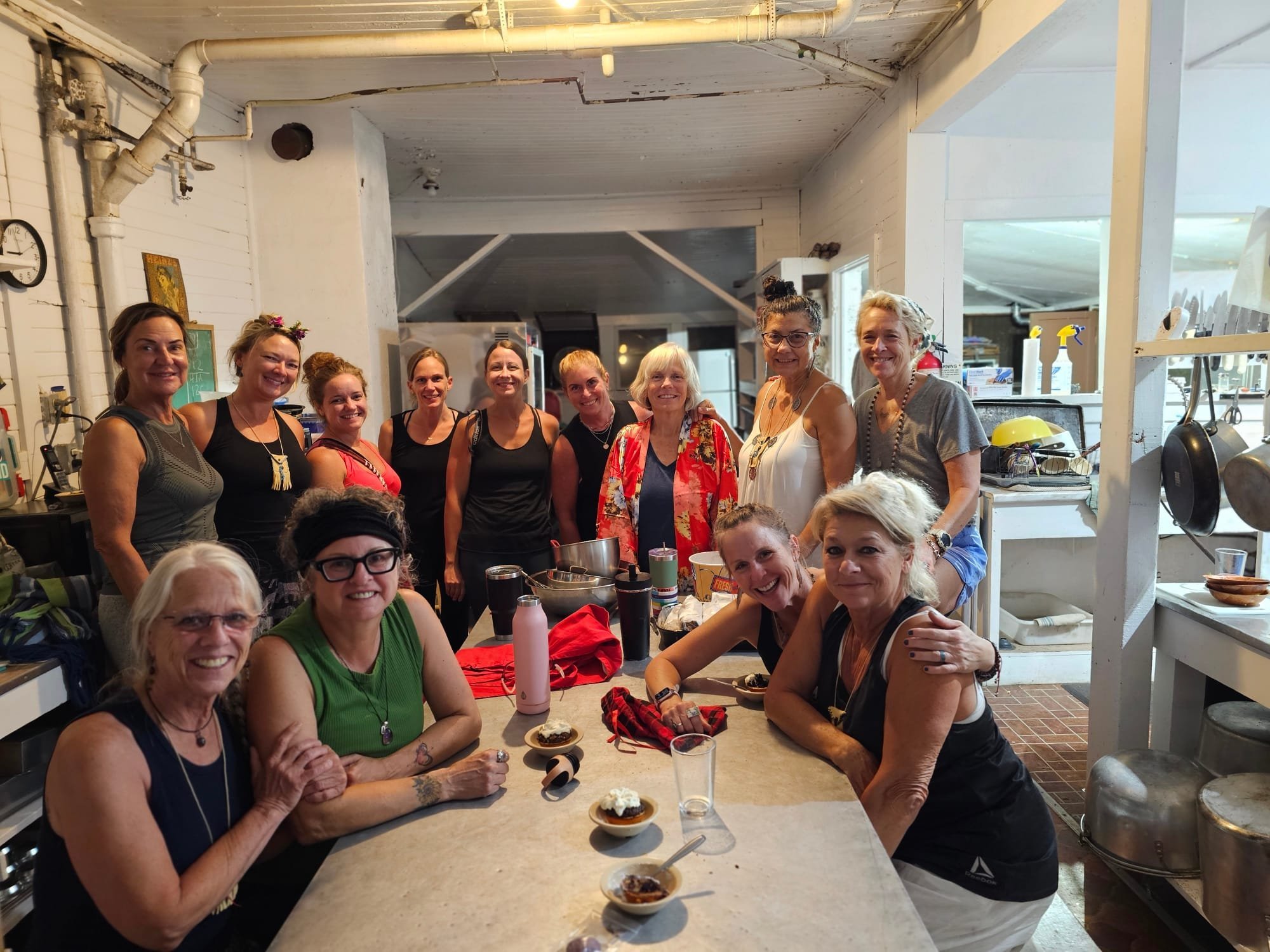 Retreat guests smiling around the kitchen table at Fox Springs Lodge