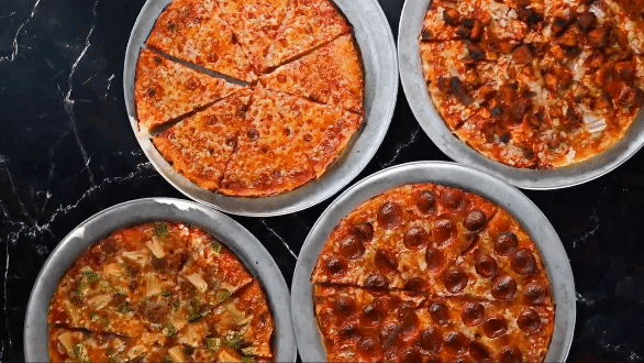 Assorted pizzas overhead view