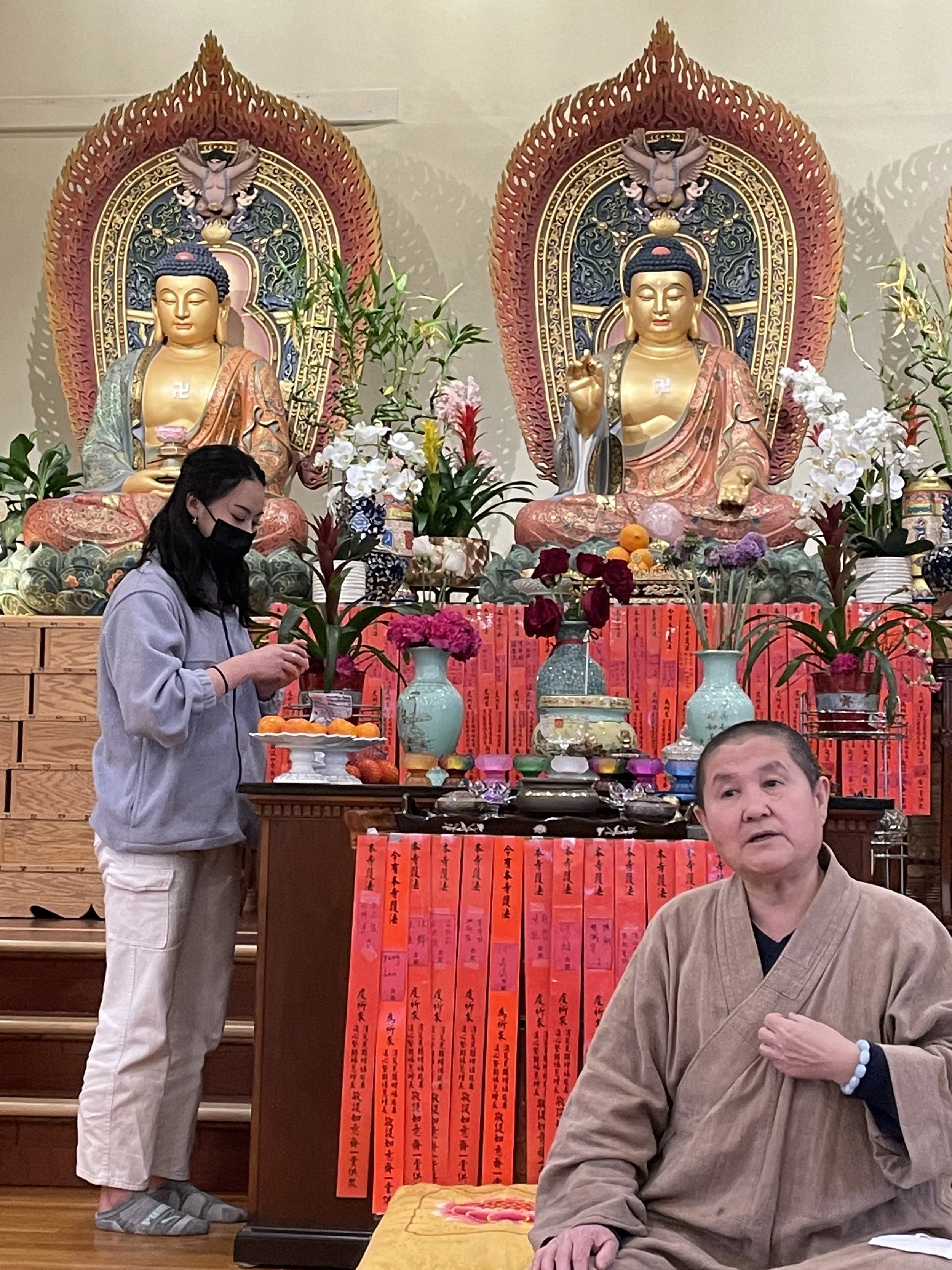 Lesley arranges oranges to offer as Dana at the American Wisdom Association in Billerica.