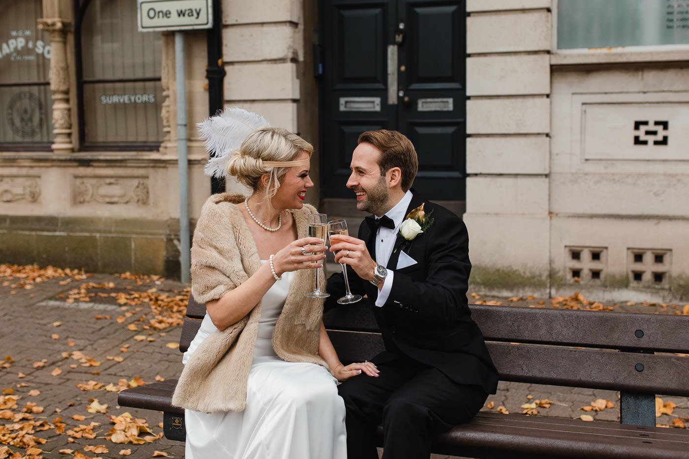 22-bride-groom-toasting-champagne-bench.jpg