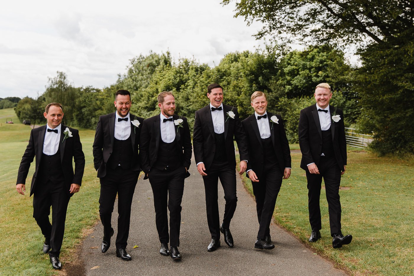 15 groomsmen walking celtic manor.jpg