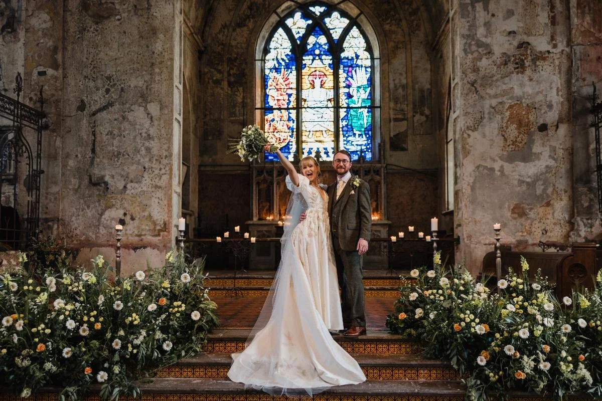 bride and groom cheering in the mount without