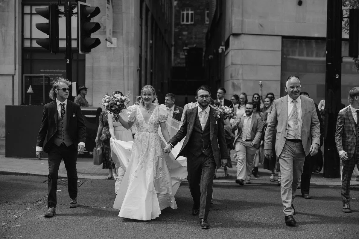 bride and groom walking through bristol centre