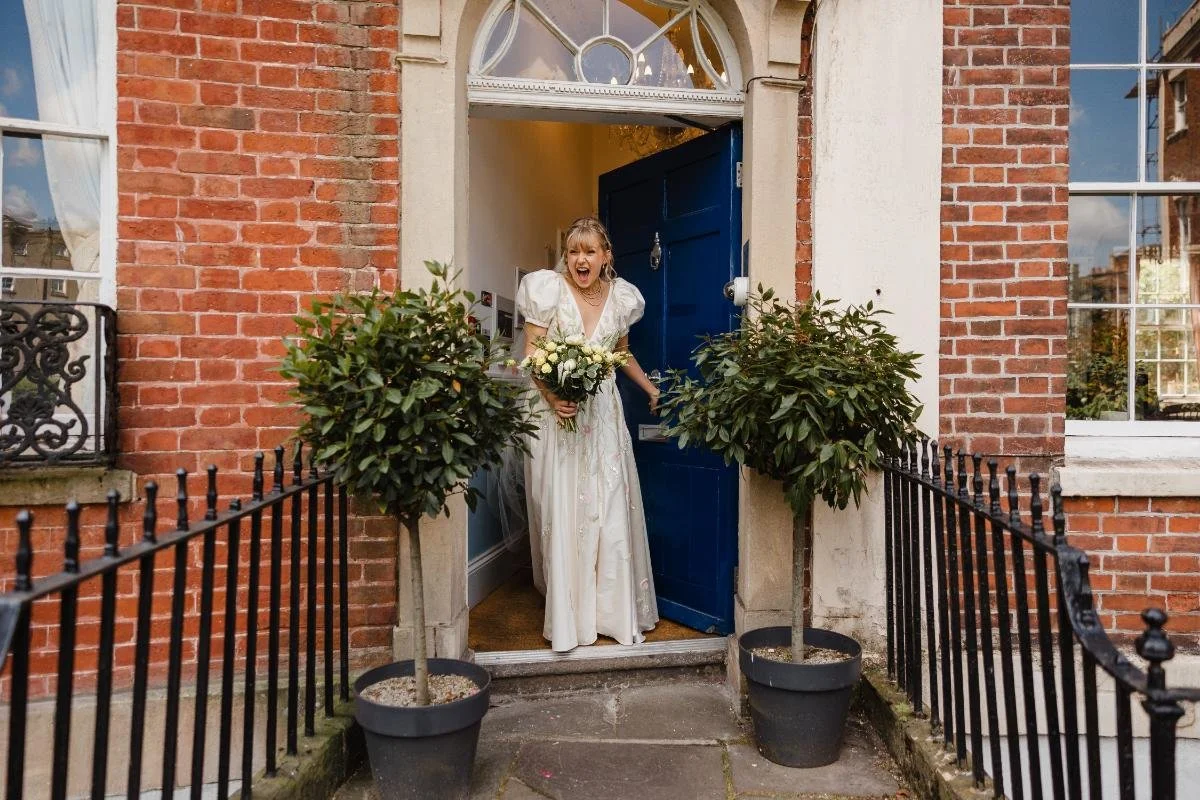 bride coming through the doorway ready to get married