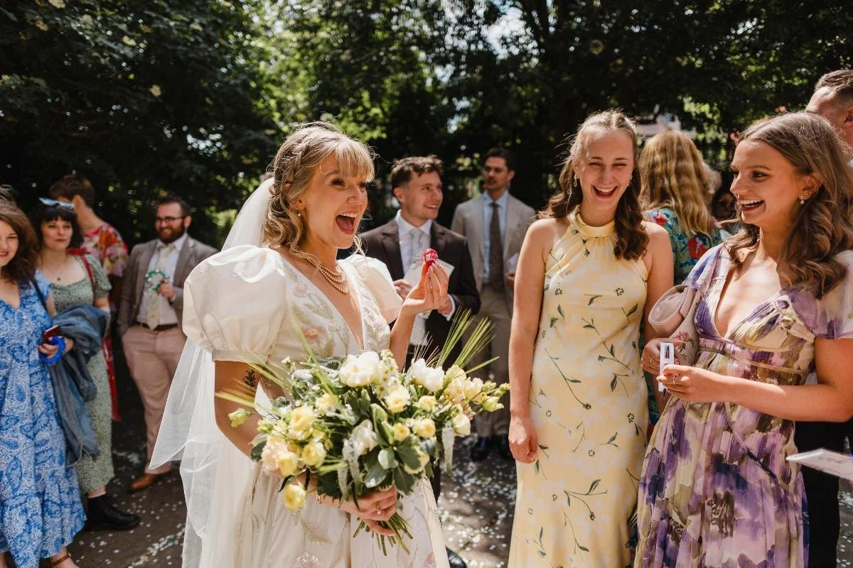 candid of bride laughing with guests outside the mount without
