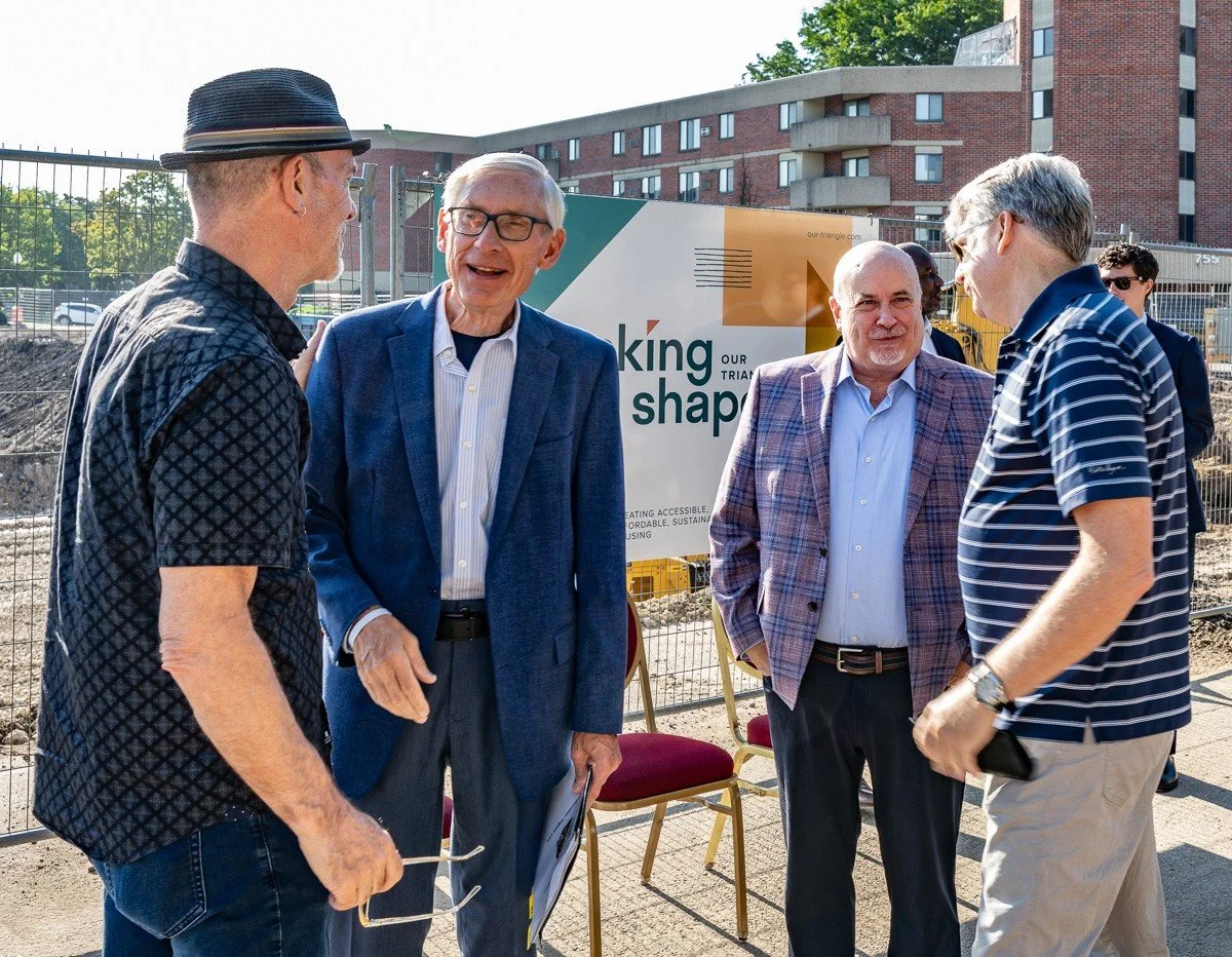 Alder Tag Evers chats with a smiling Governor Tony Evers while Dane County Board Commissioner Chuck Erickson talks to U.S. Representative Mark Pocan at the Taking Shape B1 Groundbreaking