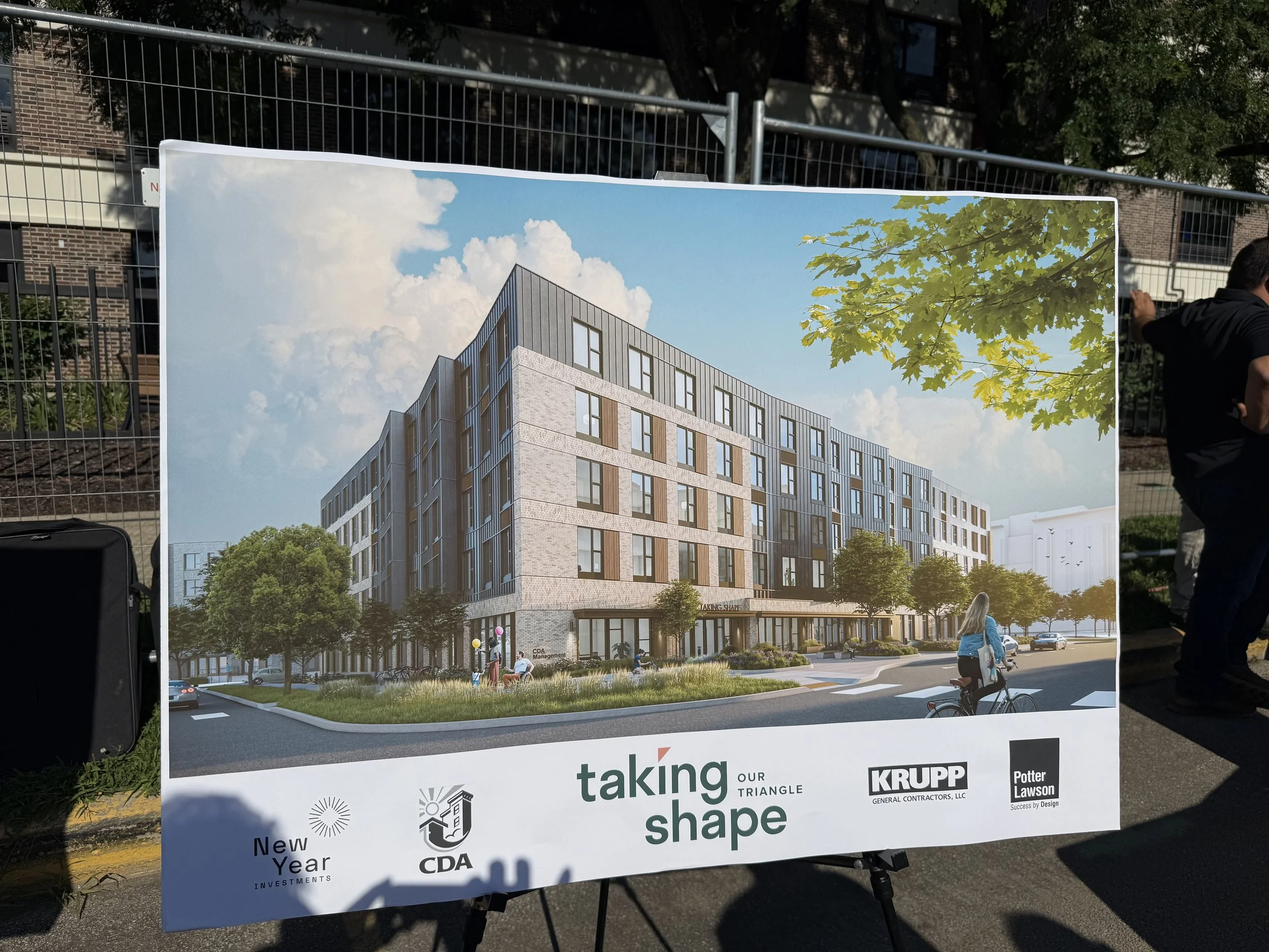 A poster rendering of Taking Shape B1, a 5 story apartment building with brick and metal panel detailing, large windows and lush landscaping.