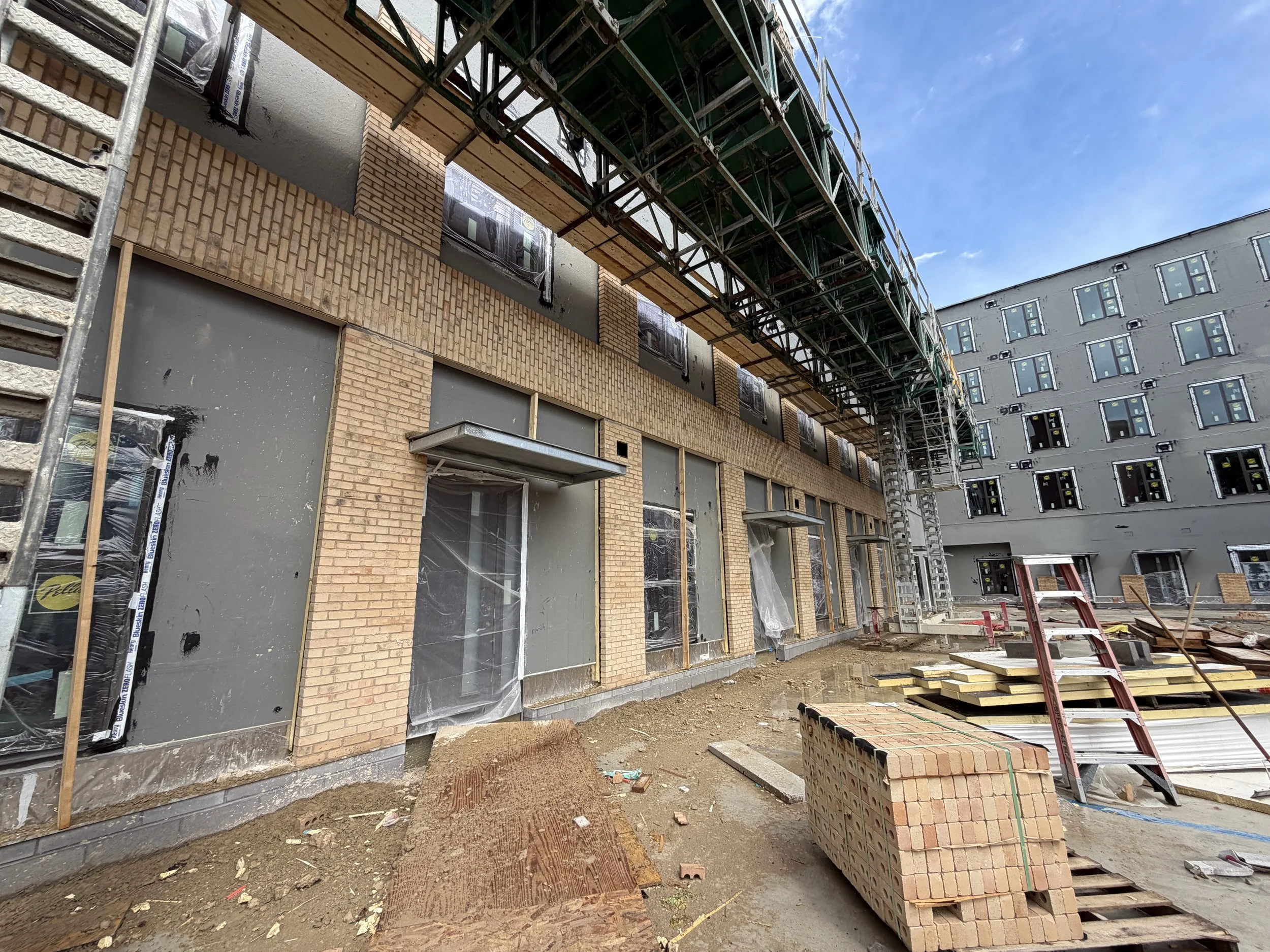 06.17.2026 - Masons continue to construct the brick facade of Luna (B1.)