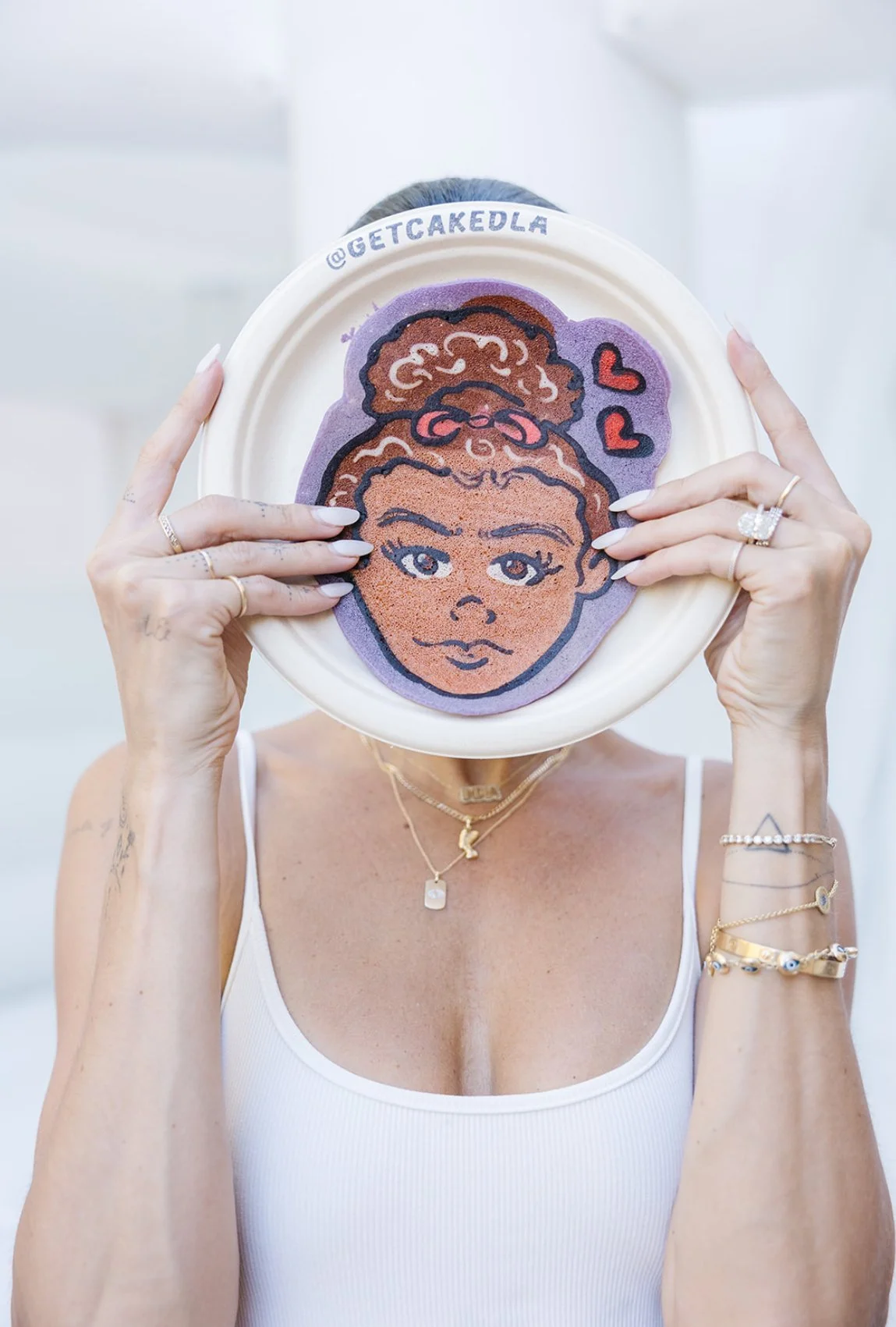 Hands holding up a pancake portrait over their face as if it was their own. Pancake art, Pancake art party, Pancake artist for hire, Pancake artist near me, Pancake artist Los Angeles, pancakes, breakfast near me, party ideas