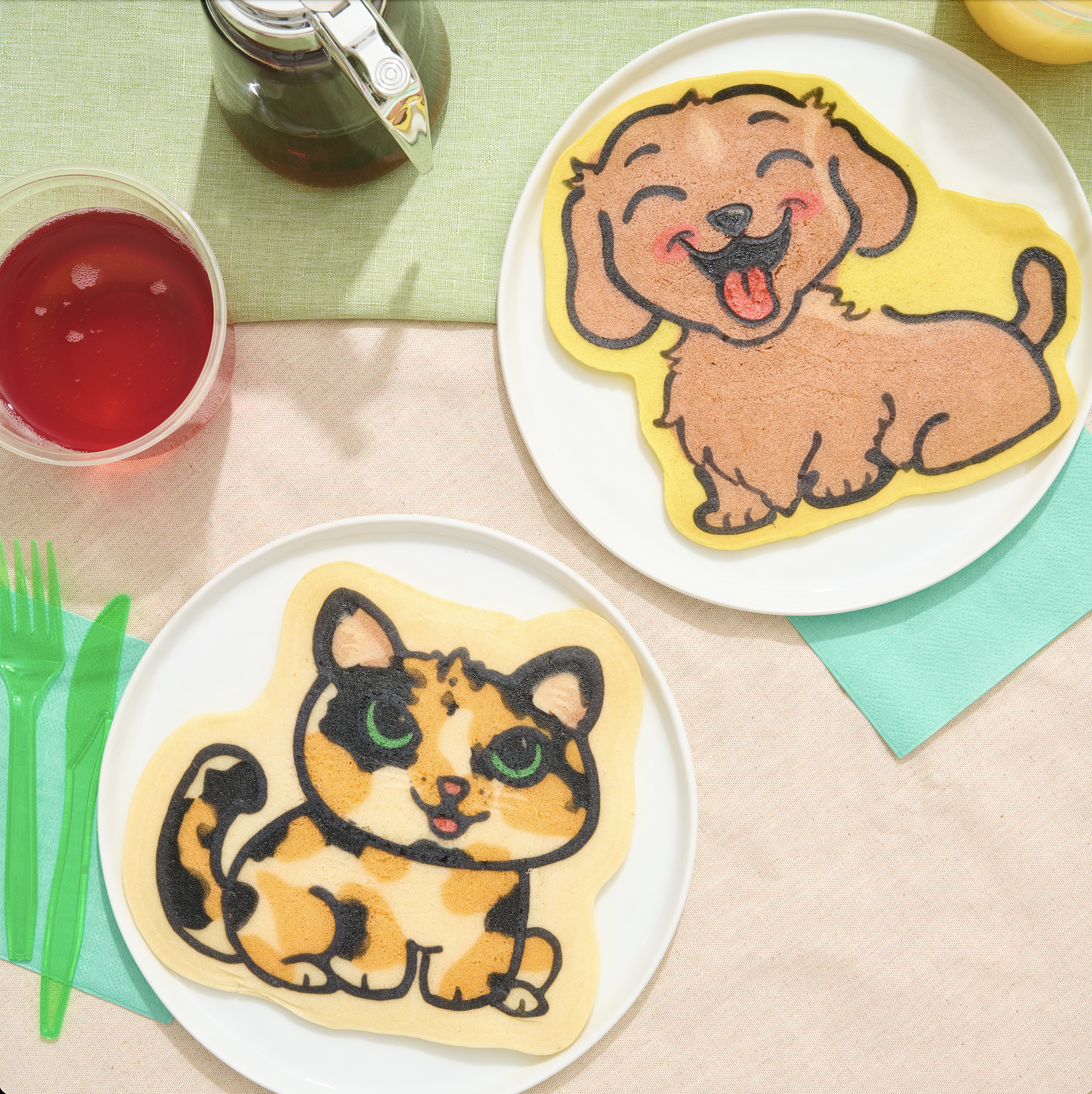 Picture of dog and cat custom pancakes each on their own individua white plate with a cup of juice. Pancake art, Pancake art party, Pancake artist for hire, Pancake artist near me, Pancake artist Los Angeles, pancakes, breakfast near me, party ideas