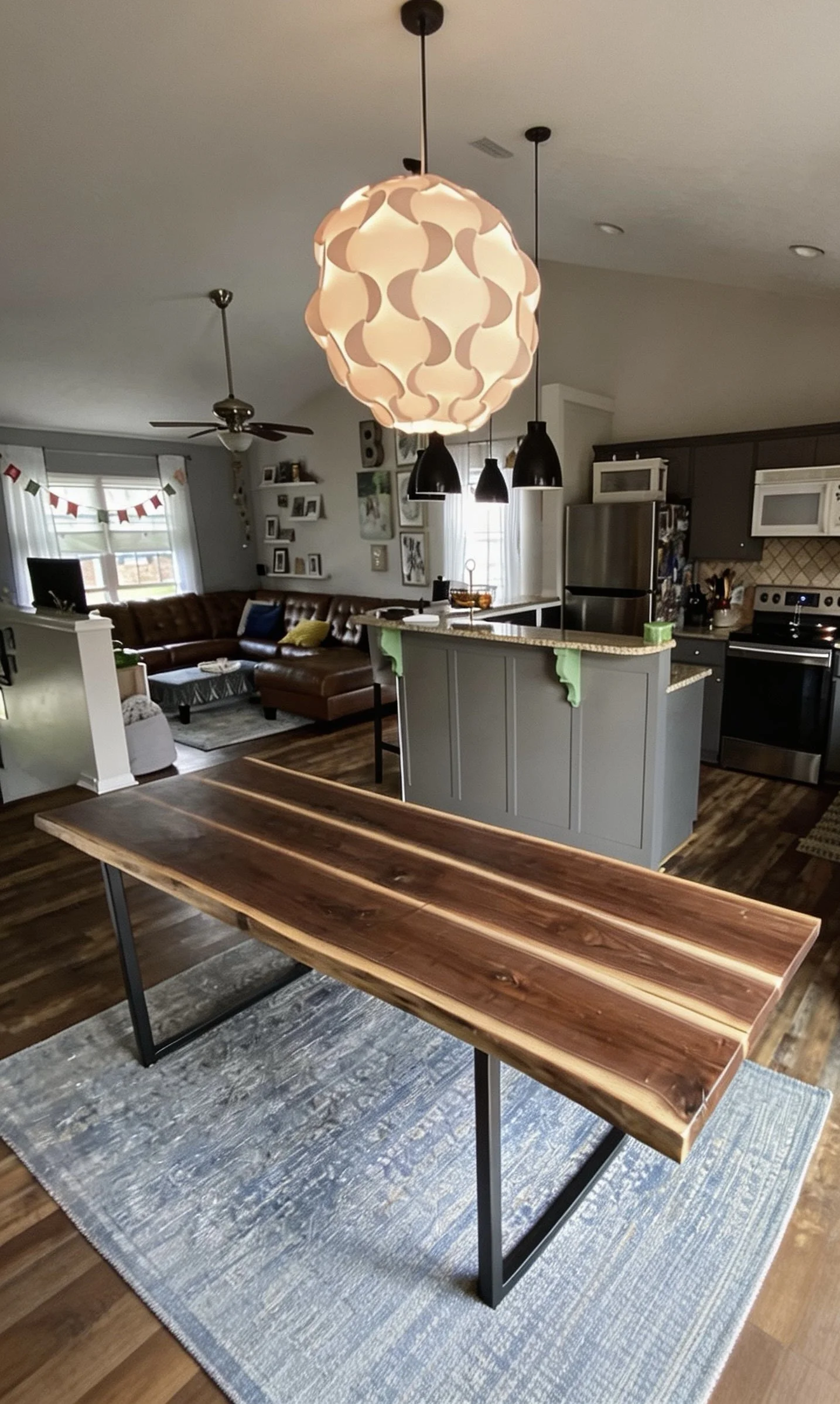 Live edge wood dining table with dark legs in a furnished home