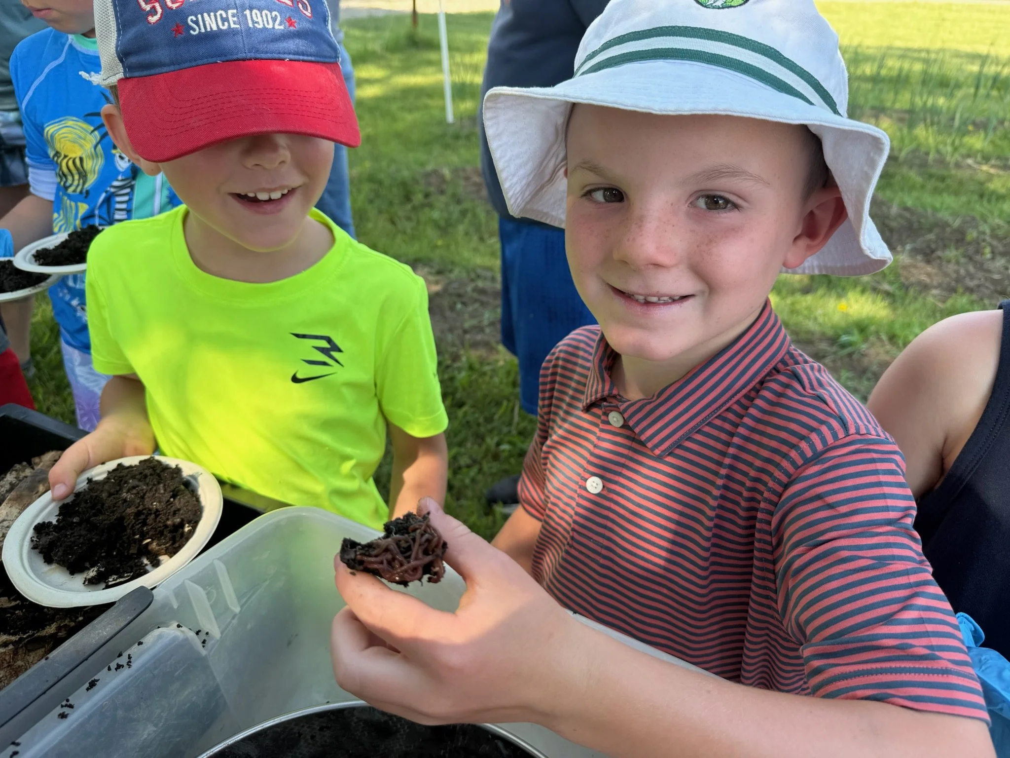 Youth camper during Sheridan County Recreation District holding a group of worms while harvesting worm castings.
