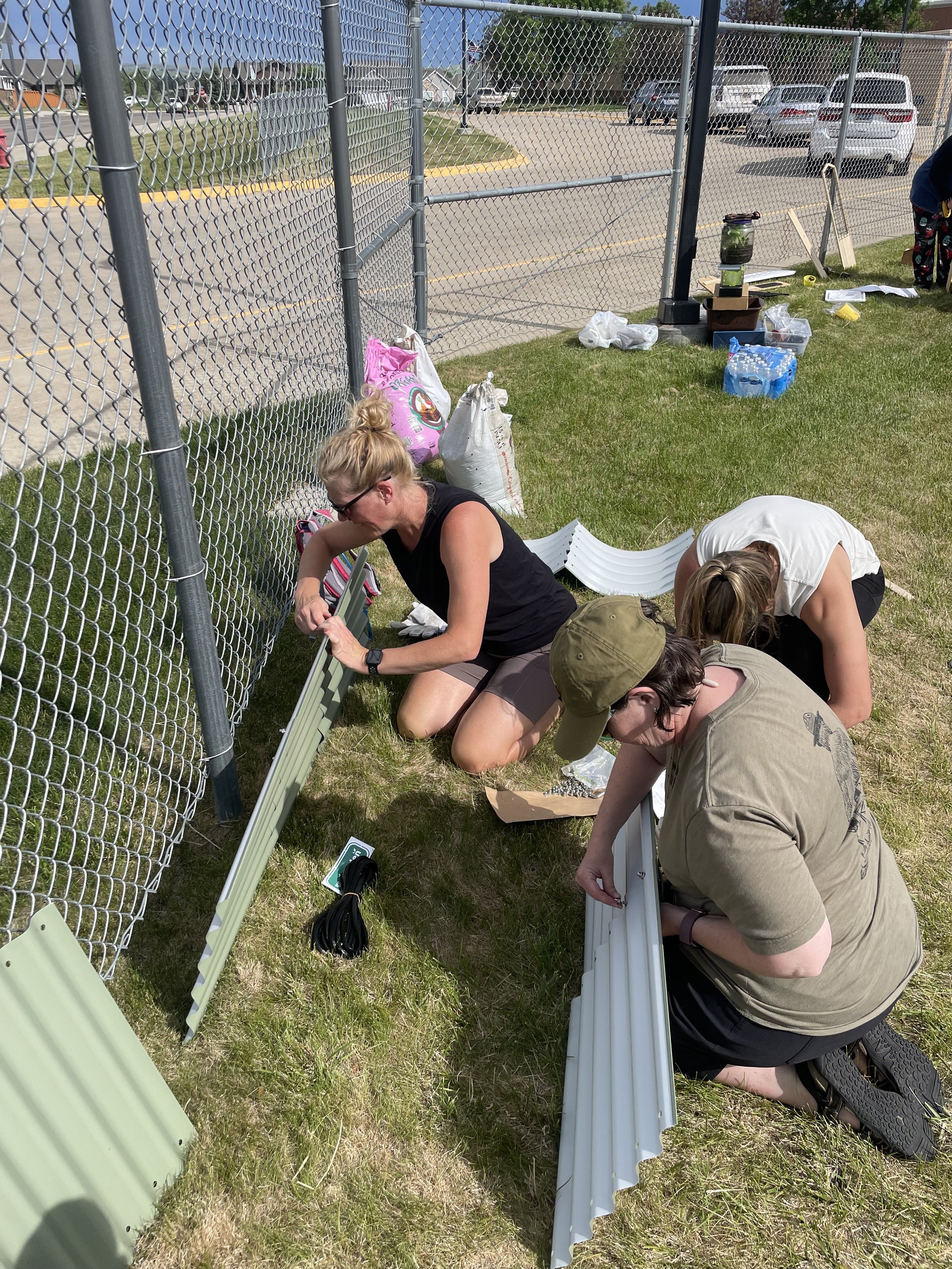 Volunteers assembling a garden bed.