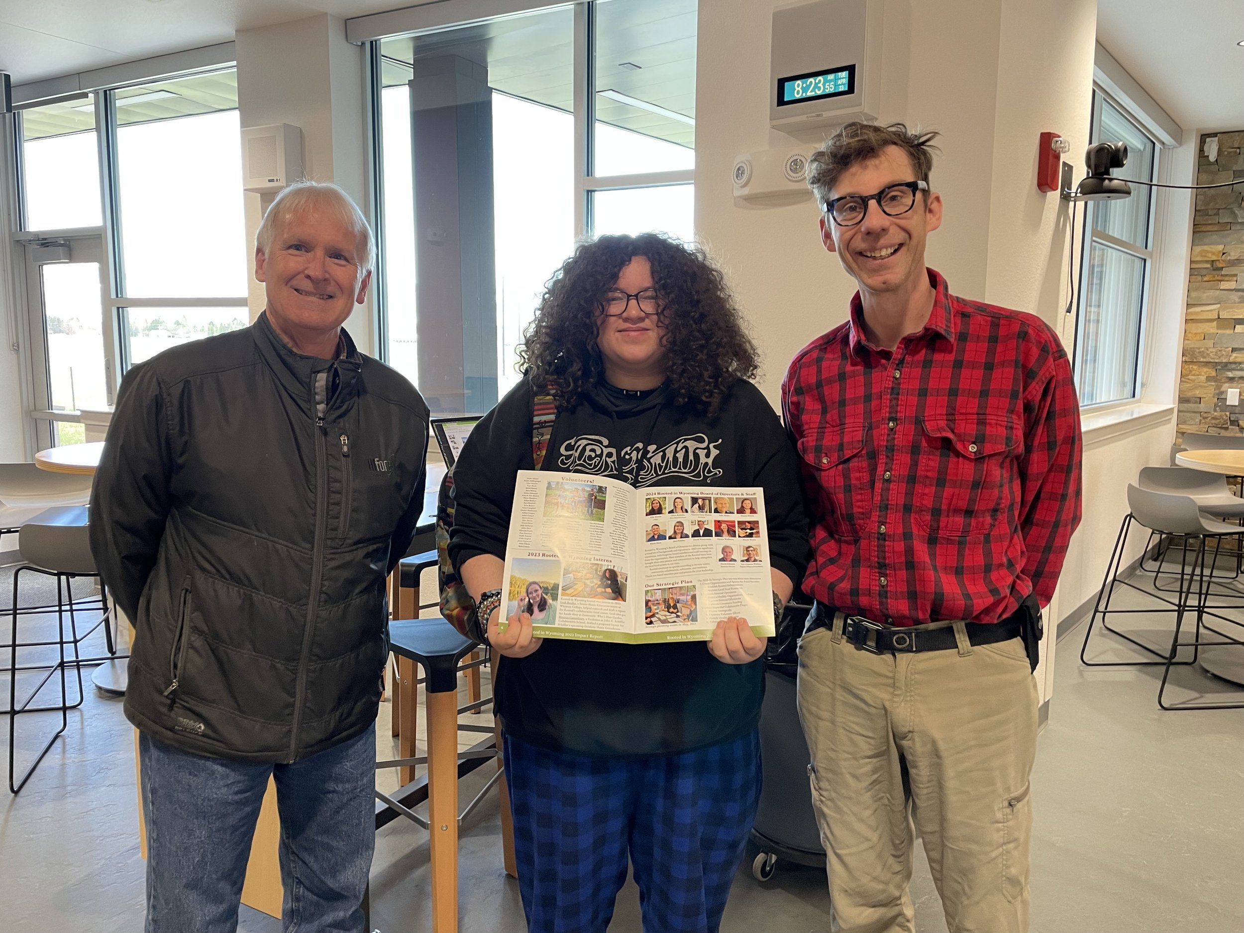 Rooted in Wyoming team posing for a photo with John C. Schieffer H.S. student intern.