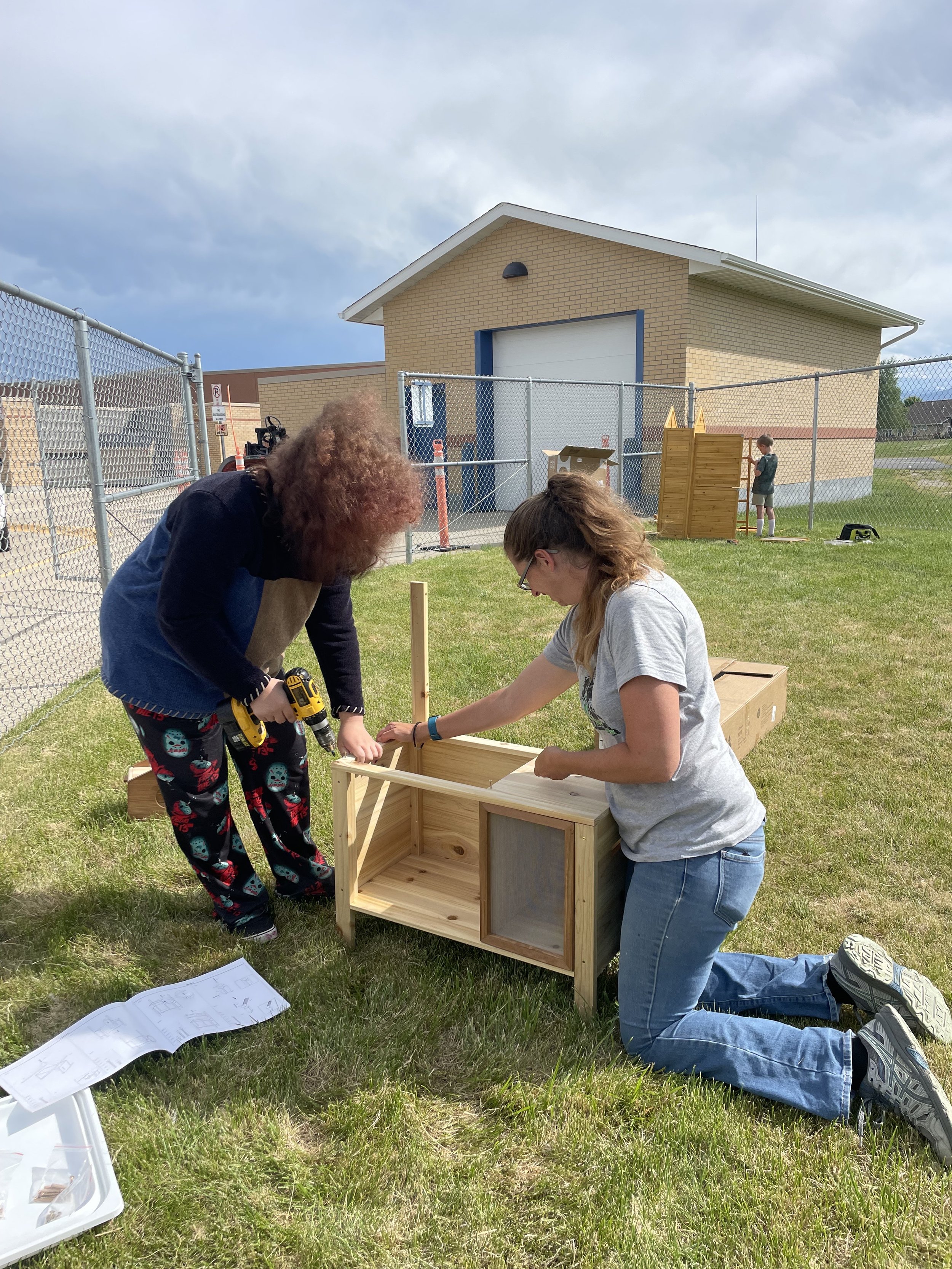 Volunteers assembling an outdoor wash station for the kids.