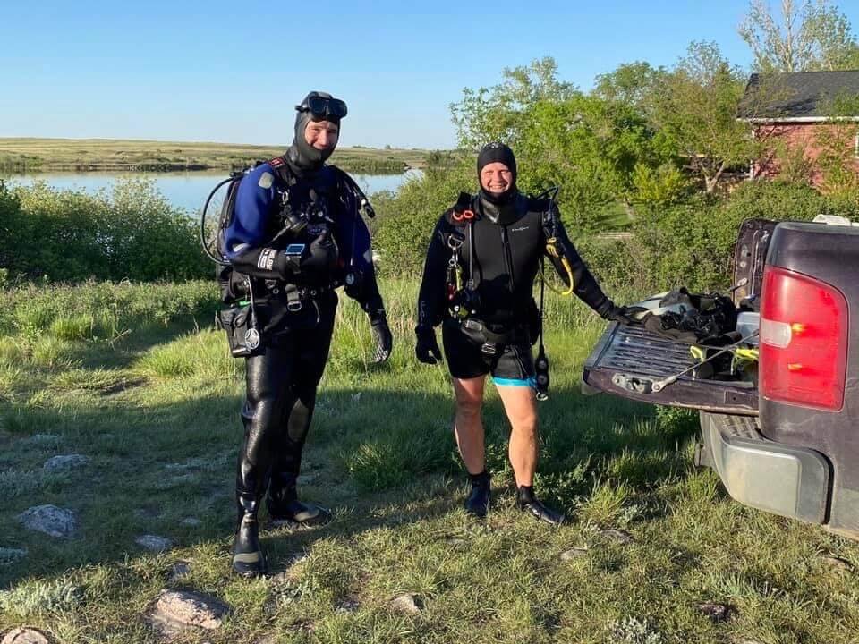 two-people-dive-gear-by-Saskatchewan-lake.JPG