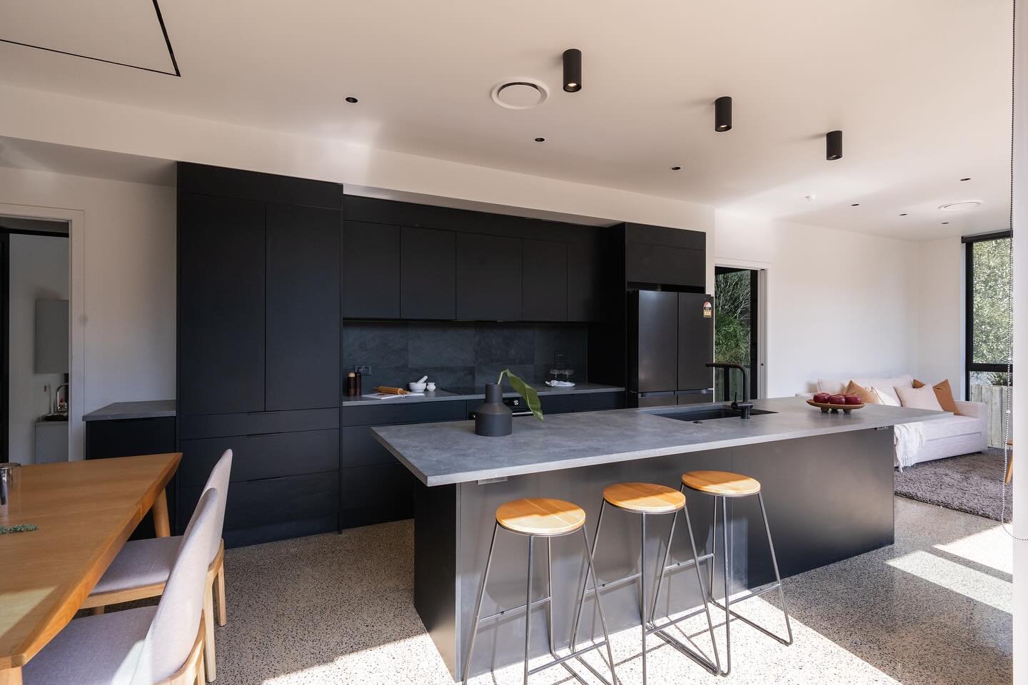 Kitchen, living space in house one of our Glendowie Project. 

Layout was key in the design as the client wanted to maximise the indoor/outdoor flow, while still keeping the comfort of a living area. 

Having the polished concrete finished floor, wit