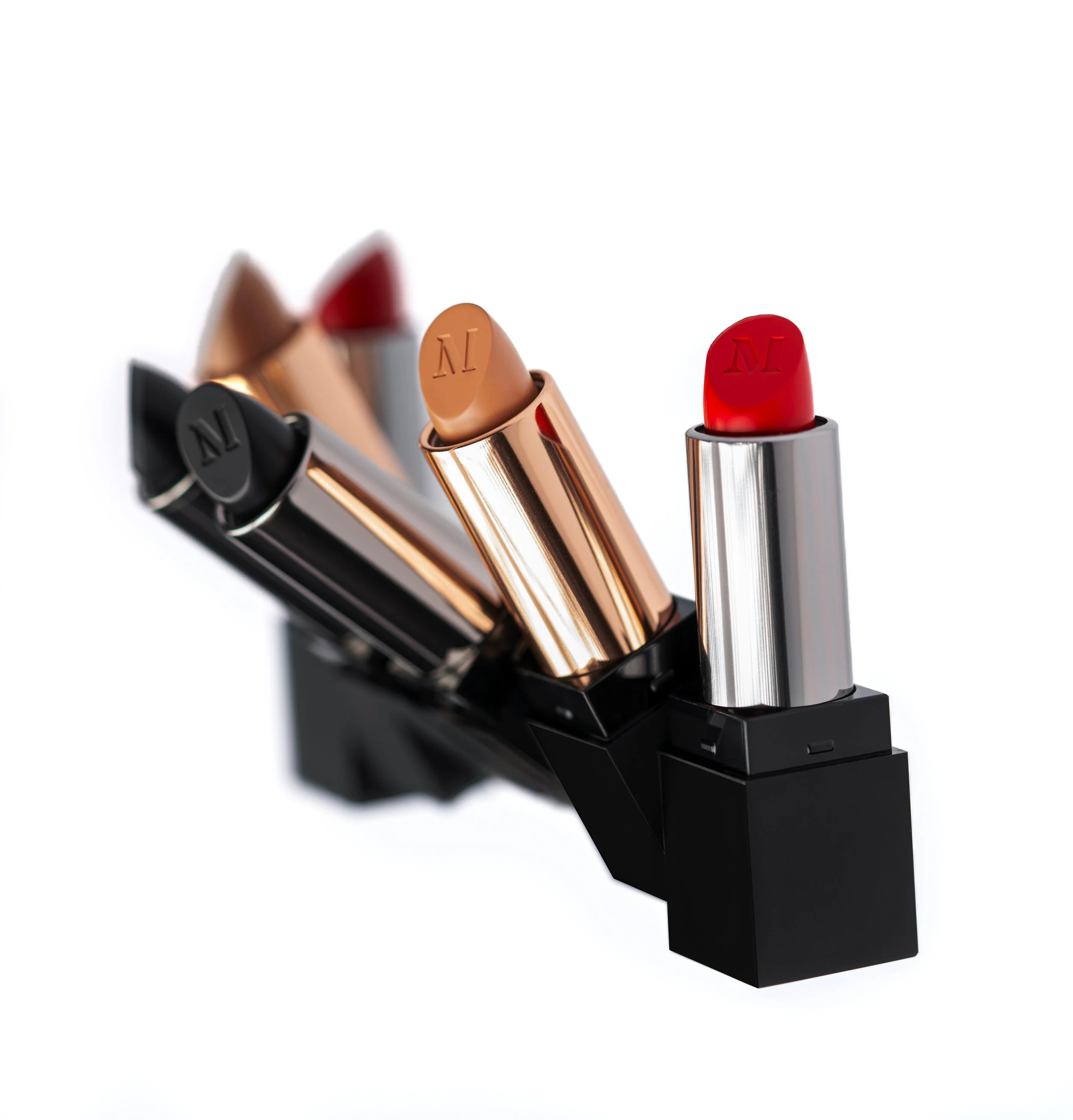 A set of assorted lipstick tubes with various colors, including red, nude, and dark shades, displayed in a black stand.