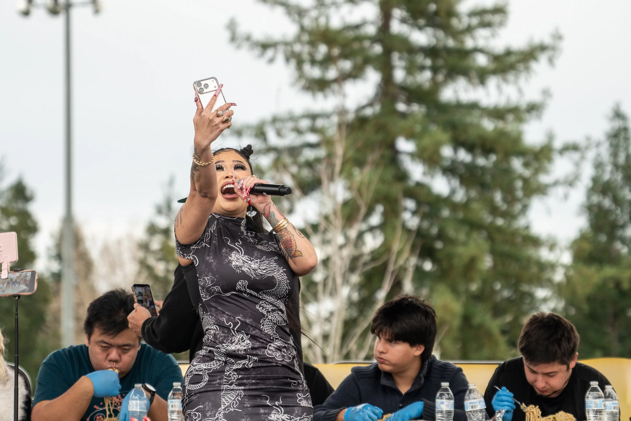 TikToker Lovelymimi hosting the 3lb shrimp eating contest with competitive eater Raina at the 2026 Elk Grove Tết Festival