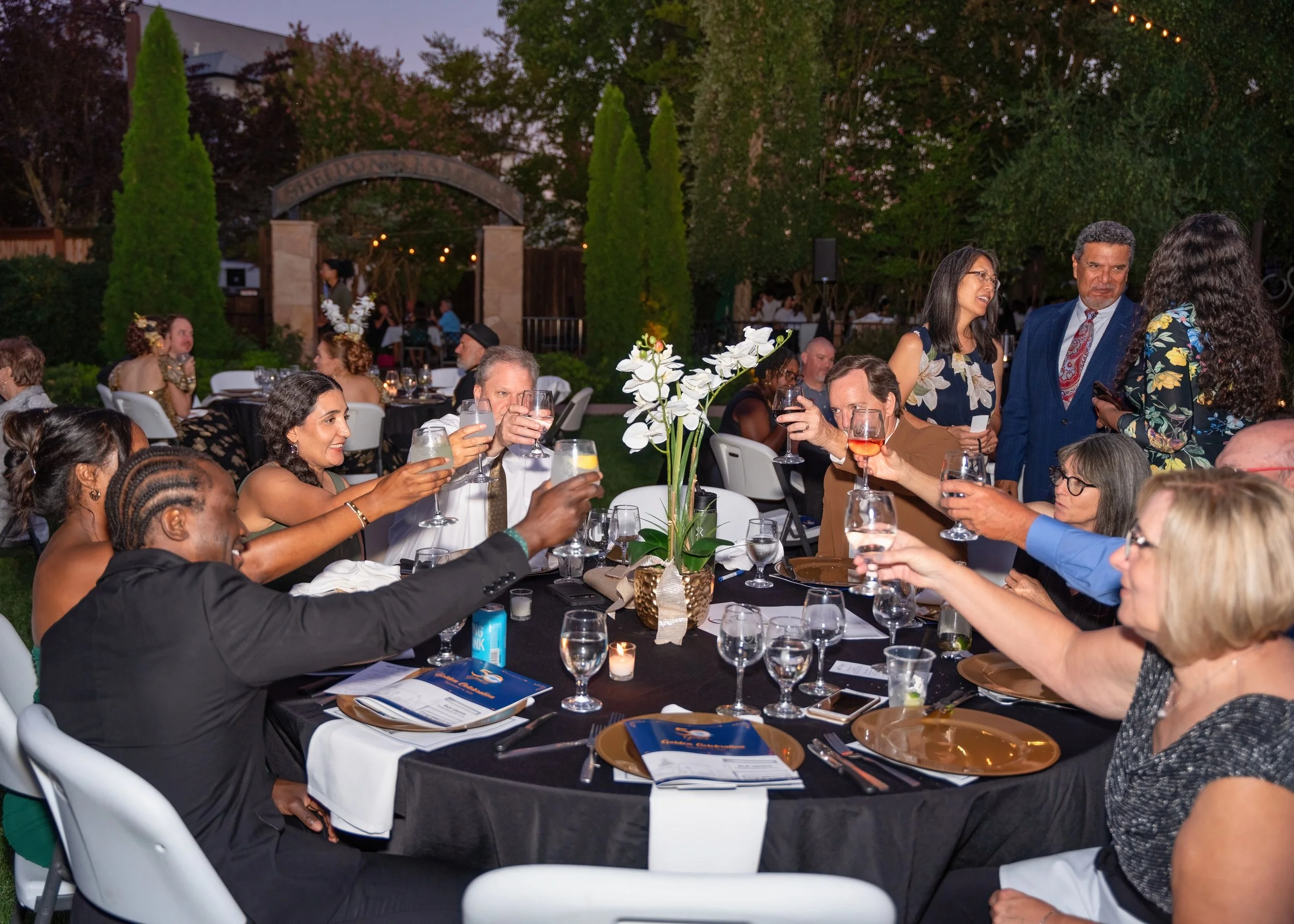 Guests raising glasses in toast at Elk Grove Food Bank Gala Sacramento event photographer
