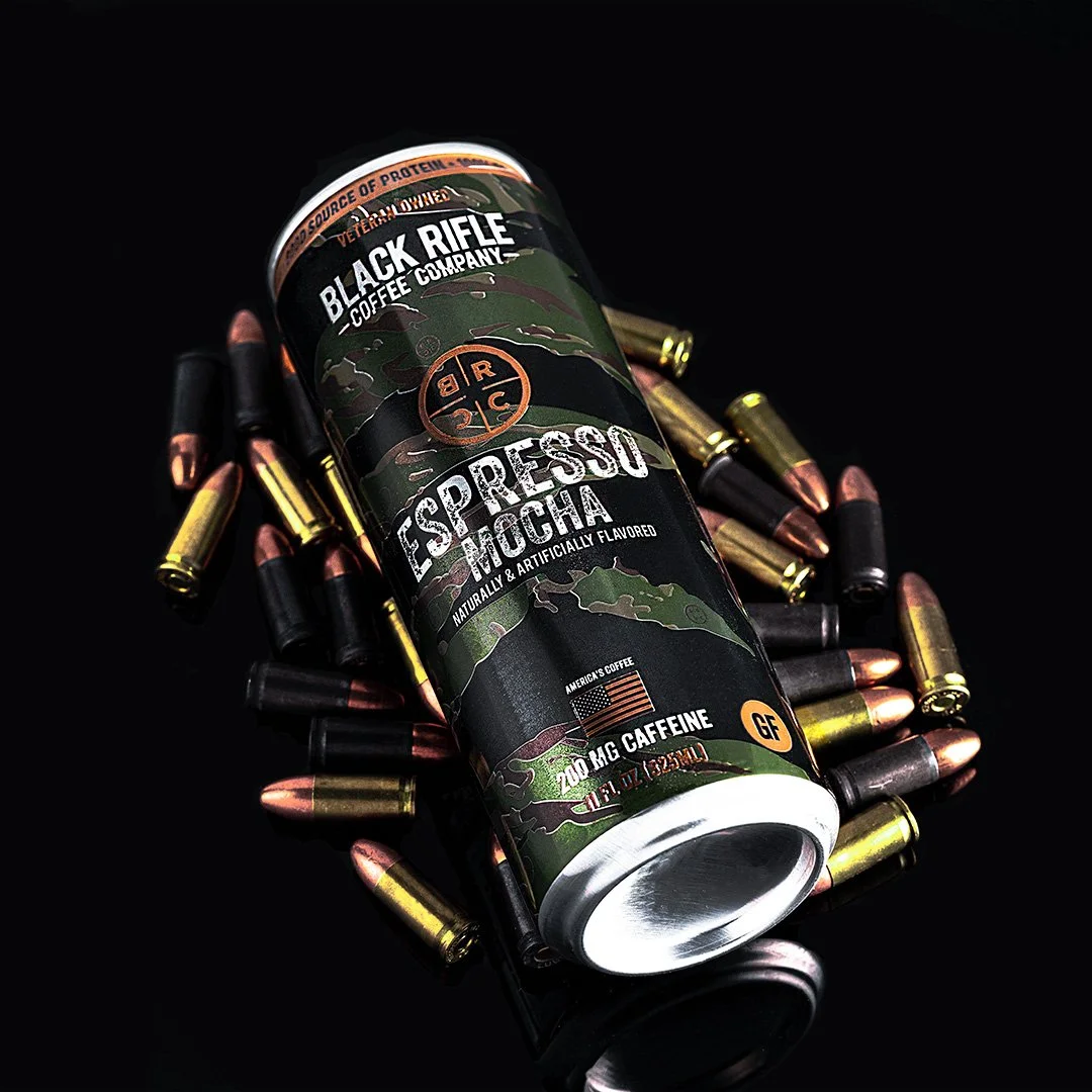 Product photography of an espresso energy drink can with dramatic lighting and styled bullet props on a dark background