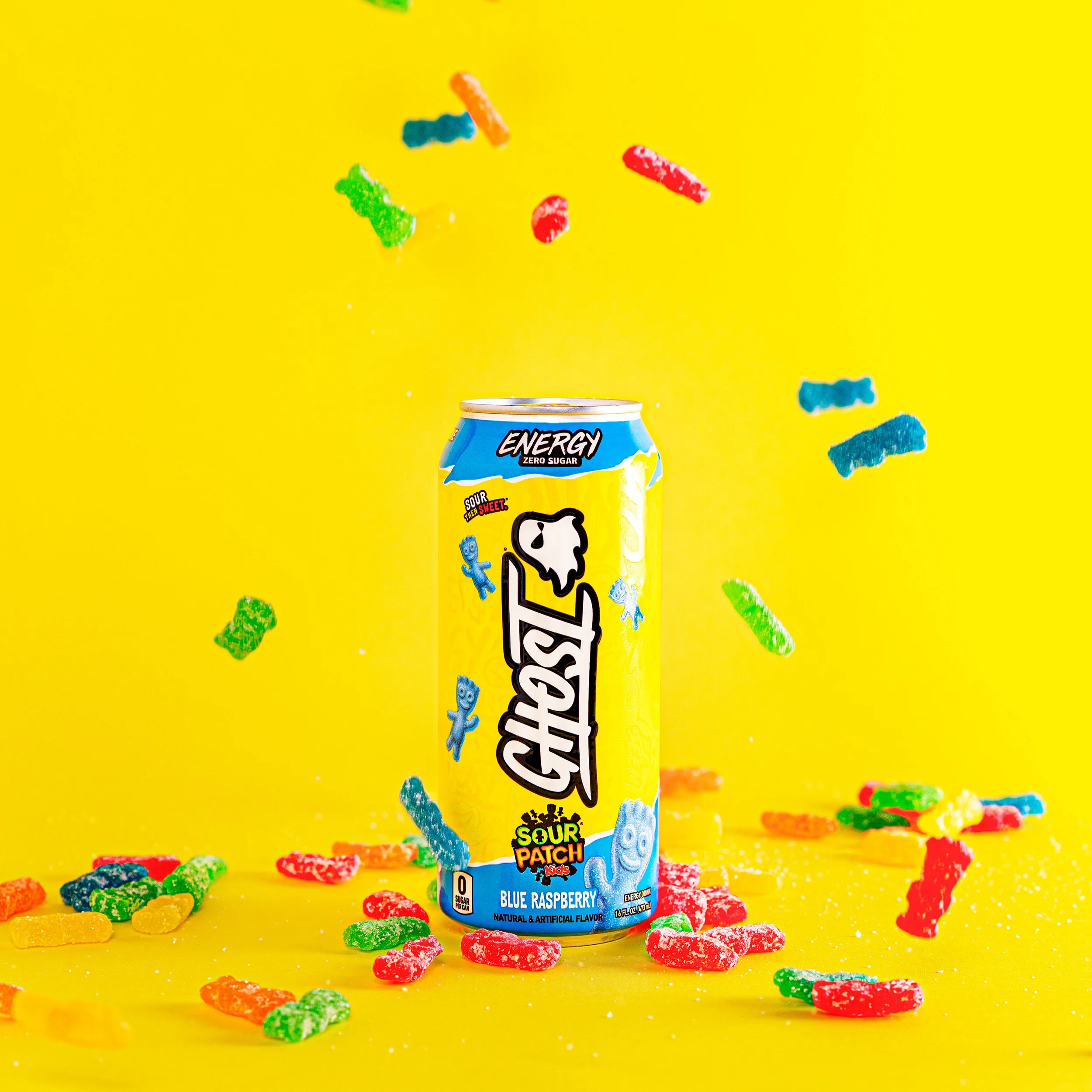 Colorful product photography of an energy drink can with sour candy on a bright yellow background