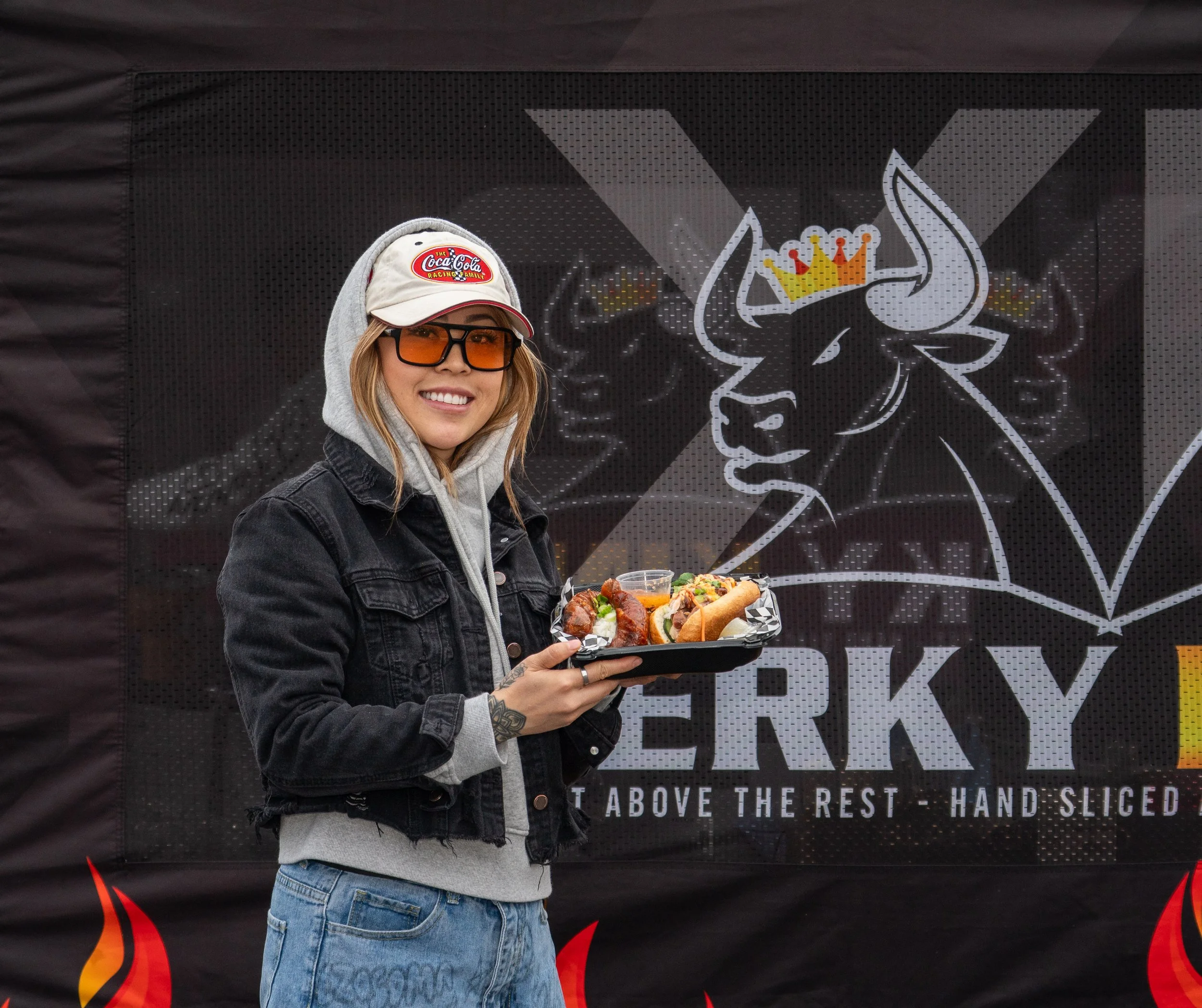  Food influencer Trangaroni holding a plate of food at the 2026 Elk Grove Tết Festival