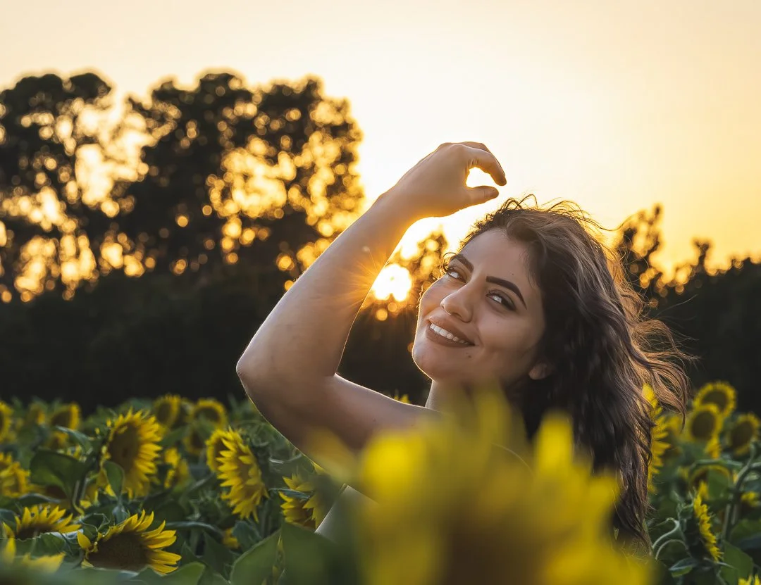 Portrait photography of a woman in a sunflower field at golden hour in Sacramento by Mad Lad Visuals