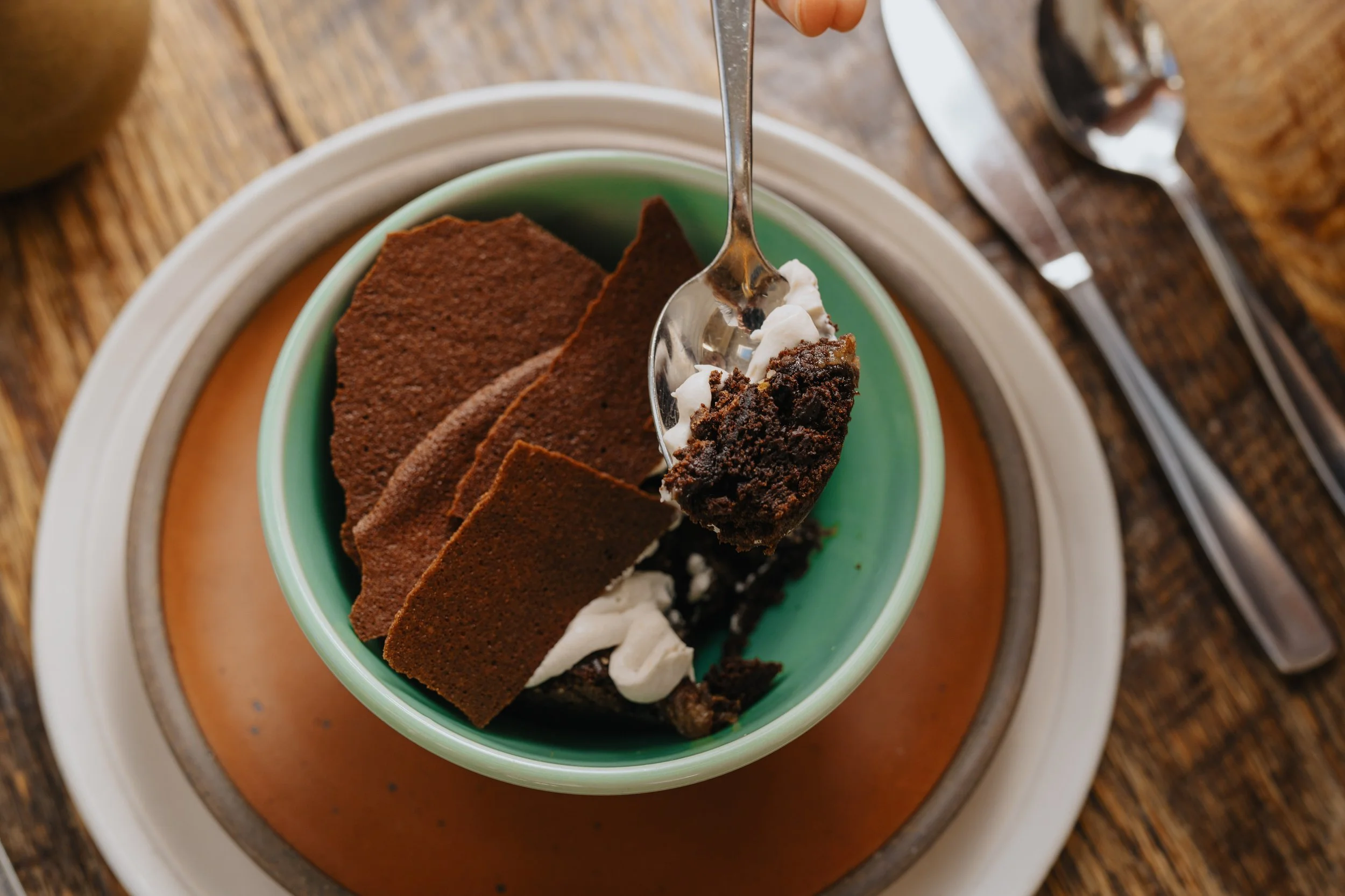 A dessert in a green porcelain bowl. Bowl made at Old School Farm Pottery, a nonprofit Nashville Pottery