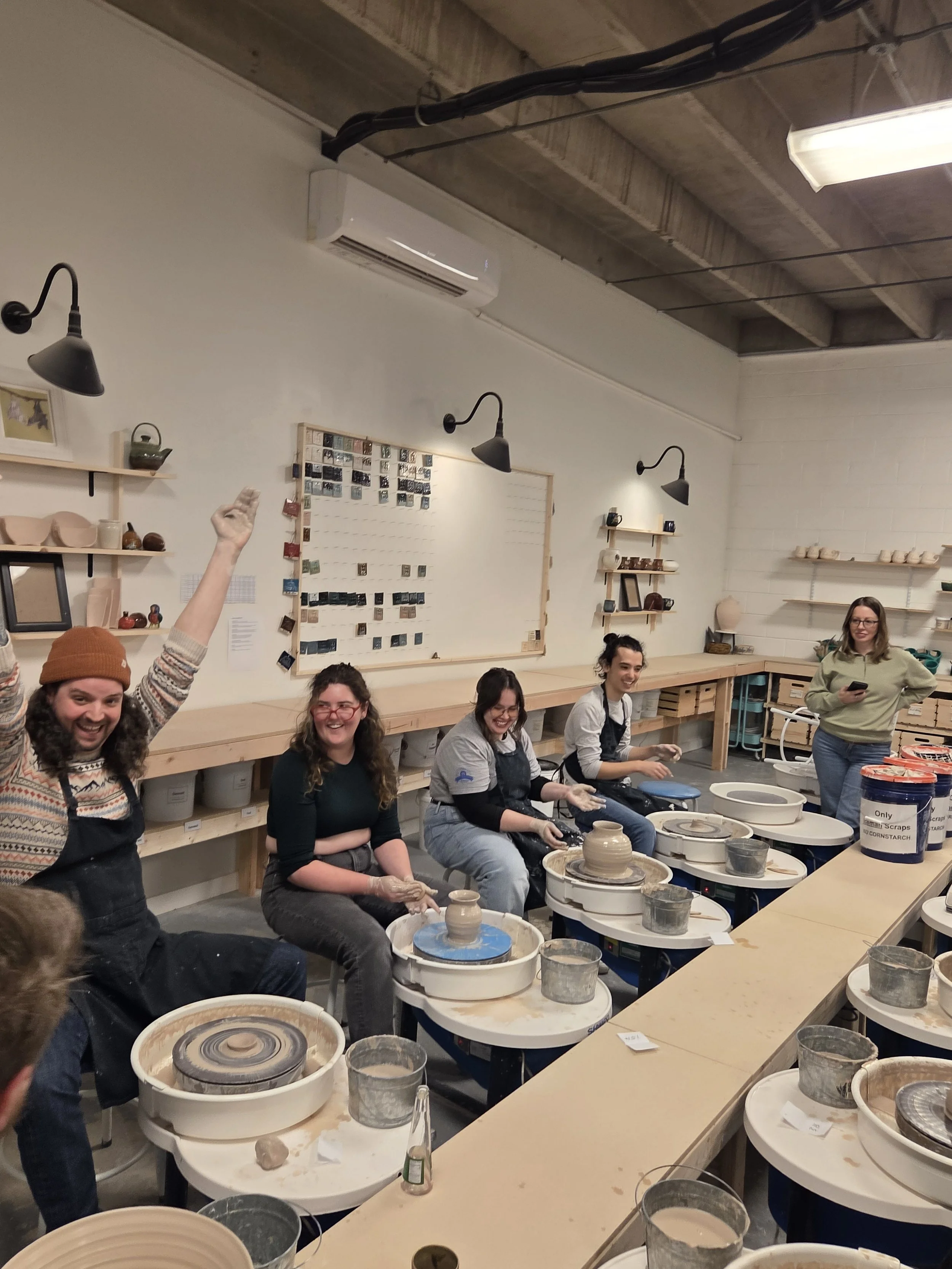 Studio members playing musical chairs with the pottery wheel. At Old School Farm Pottery, a nonprofit Nashville Pottery
