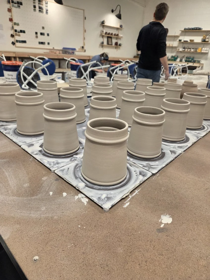 A group of thrown mug forms sitting on a table. Made at Old School Farm Pottery, a nonprofit Nashville Pottery.