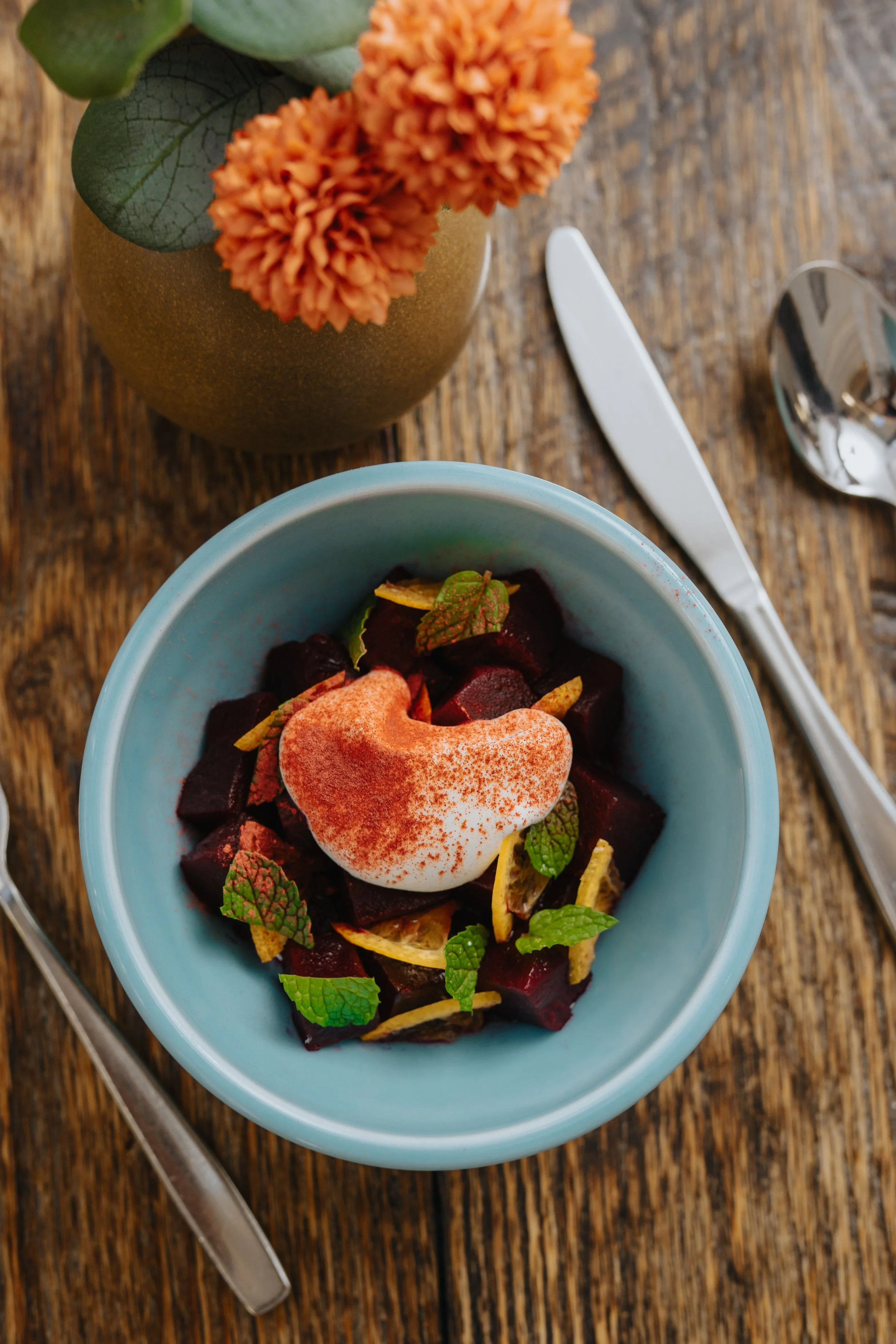 A salad in a blue porcelain bowl. Bowl made at Old School Farm Pottery, a nonprofit Nashville Pottery