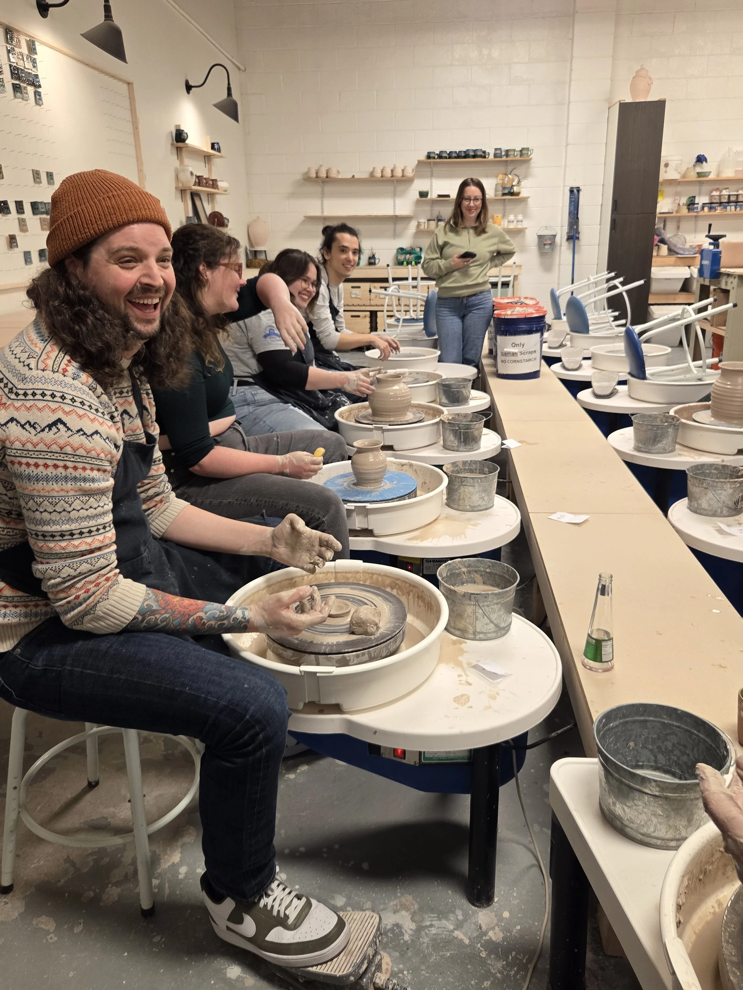 Studio members playing musical chairs with the pottery wheel. At Old School Farm Pottery, a nonprofit Nashville Pottery