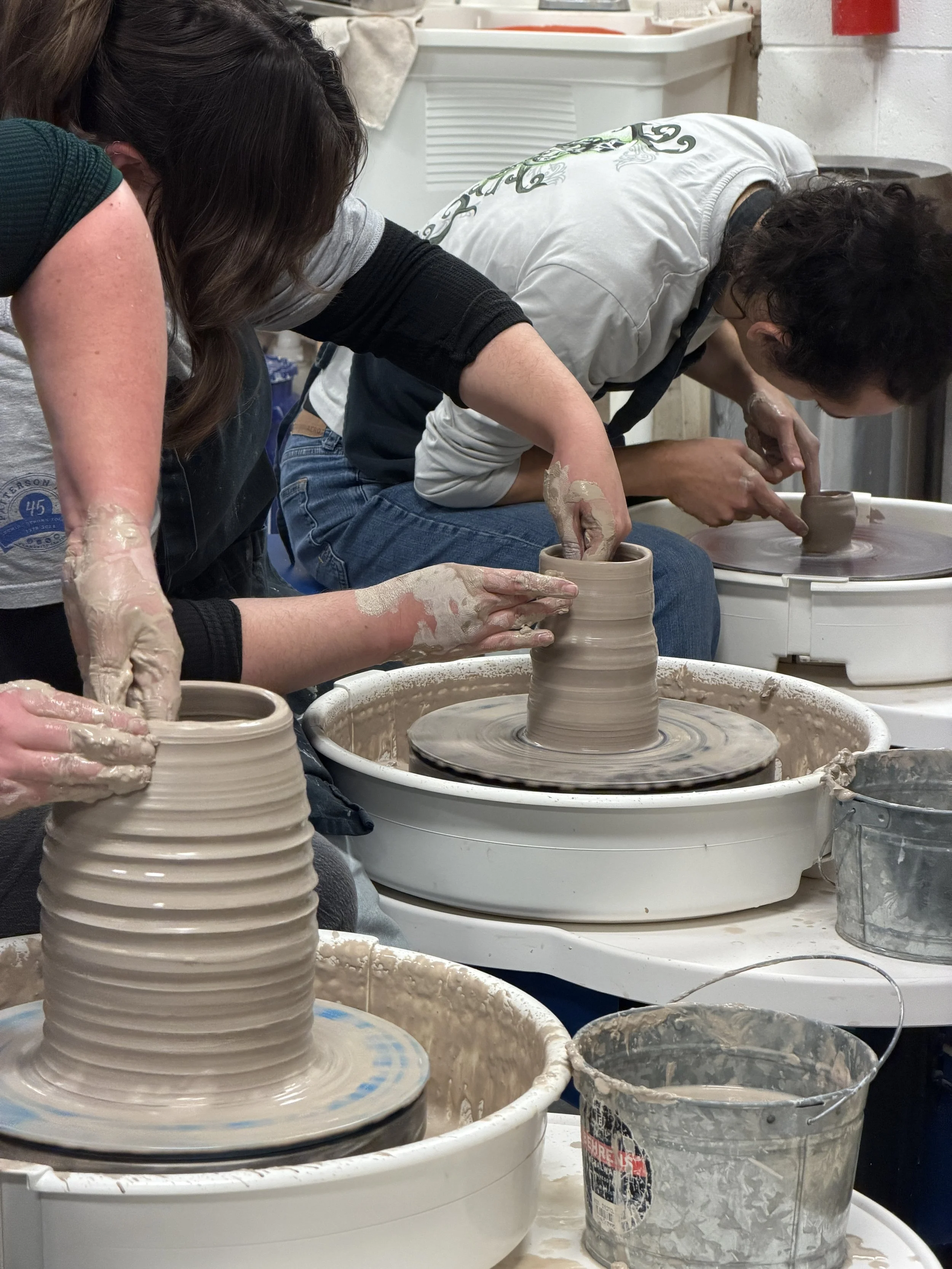 Hands forming vessels on a pottery wheel. At Old School Farm Pottery, a nonprofit Nashville Pottery