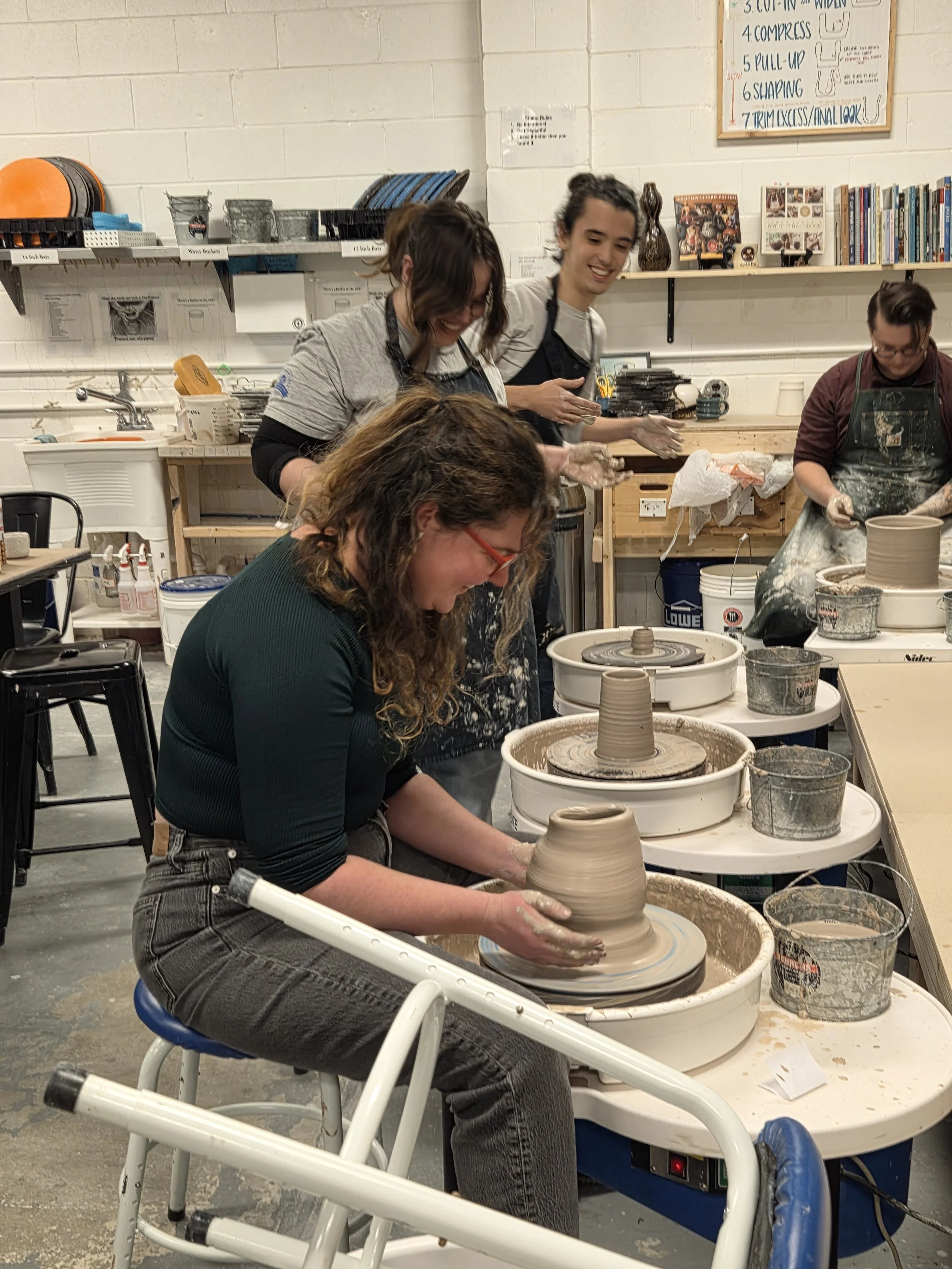 Studio members playing musical chairs with the pottery wheel. At Old School Farm Pottery, a nonprofit Nashville Pottery