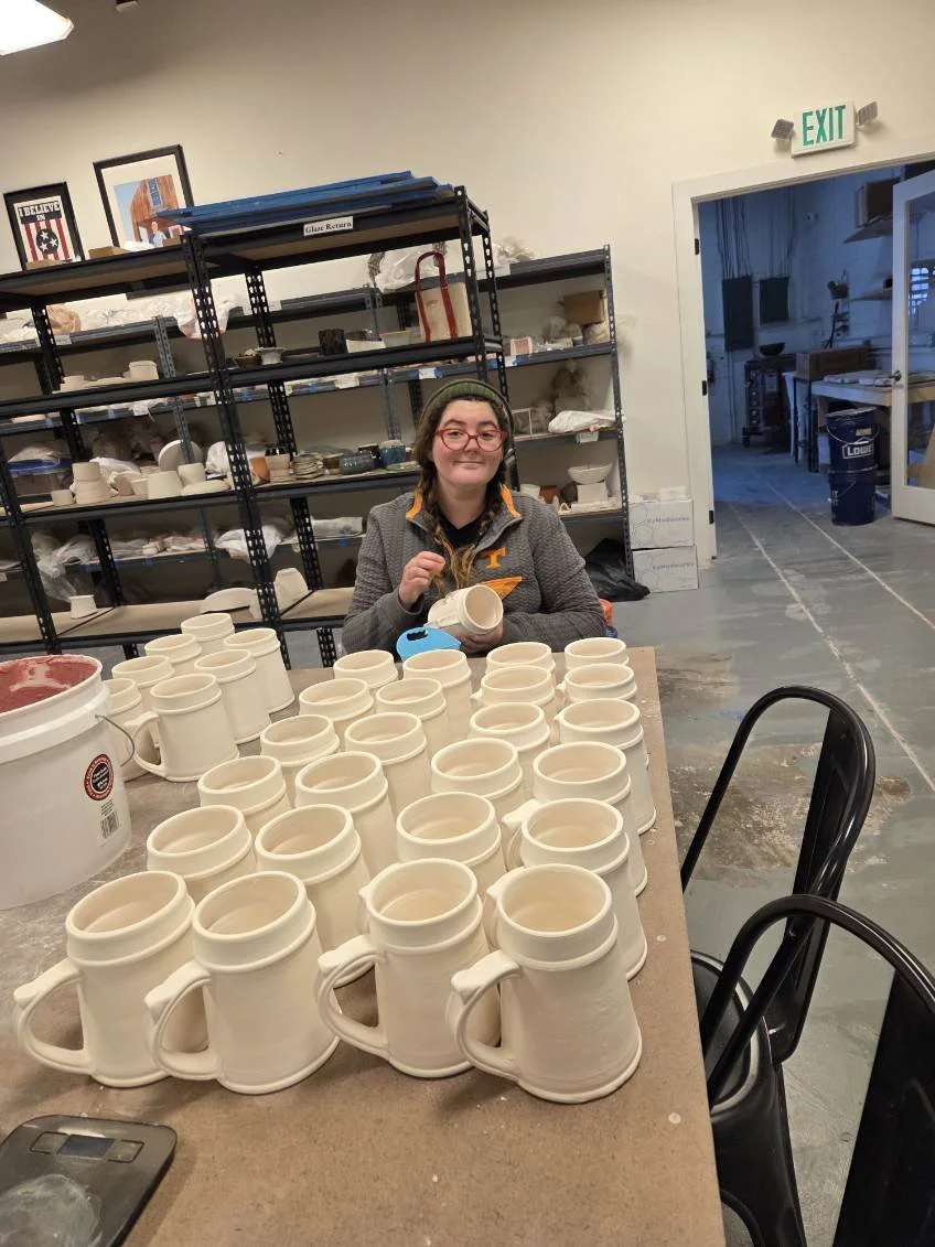 A potter, Sarah, filling in custom made medallions with custom made red glaze. Made at Old School Farm Pottery, a nonprofit Nashville Pottery.